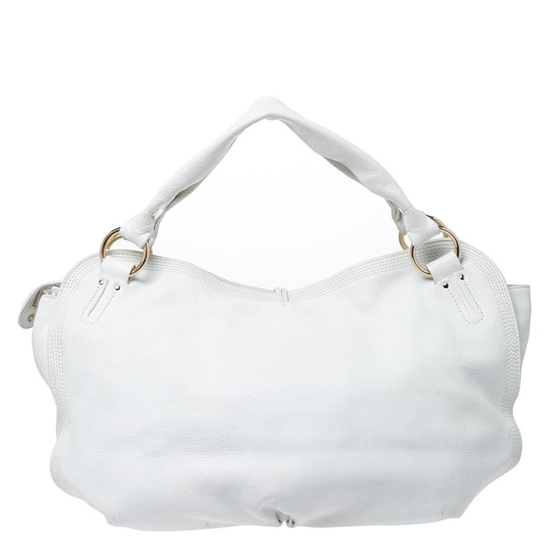 This spacious Celine ‘Bittersweet’ hobo is stylish and practical. It is crafted from white leather and is equipped with handles, top zip closure and a drop charm at the front. The spacious bag opens up to a fabric-lined interior that has multiple