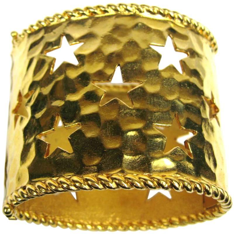 Stunning wide Celine Cuff. Hammered Gold tone Metal, Cut outs in the shapes of stars. Double safety claps Hinged, more like a side clamper.  Hallmarked Celine G1 #401, Measures 2.25 in Wide or 57.7MM. This is out of a massive collection that