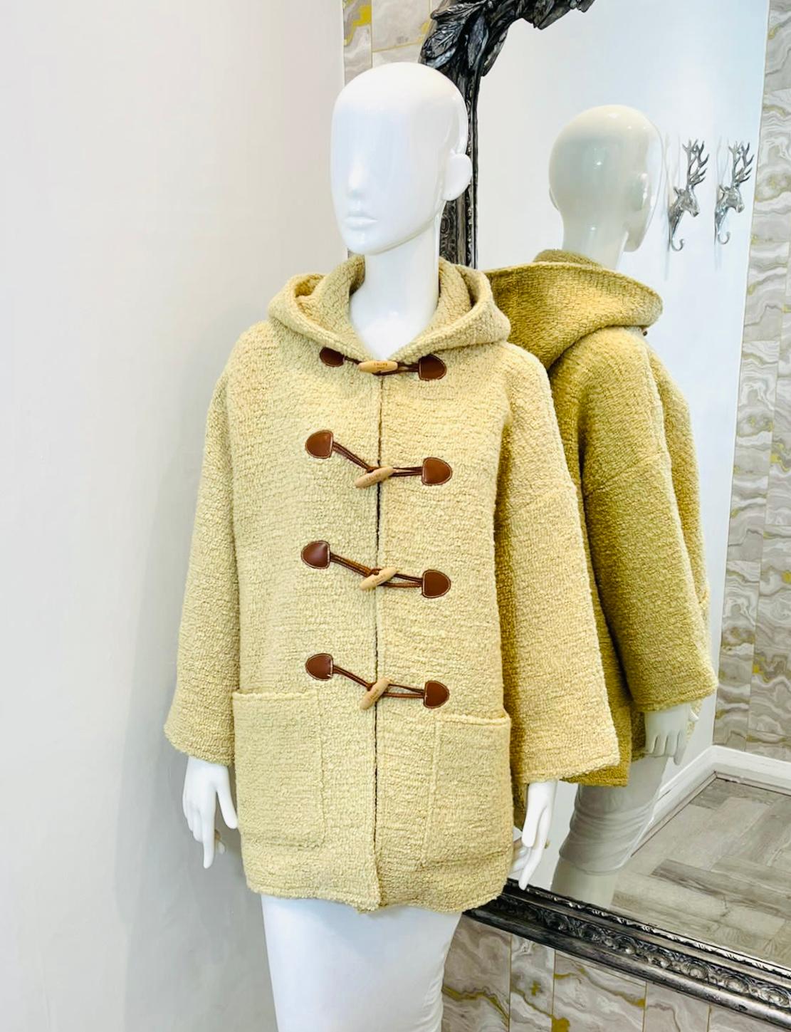 Celine Wool Duffle Coat

Beige hooded coat designed with leather and wood Brandenburg closure detailed with 'Celine Paris' logo engraved.

Featuring side slits and wide open pockets on the sides. Rrp £2250

Size – 36FR

Condition – Very Good (Small