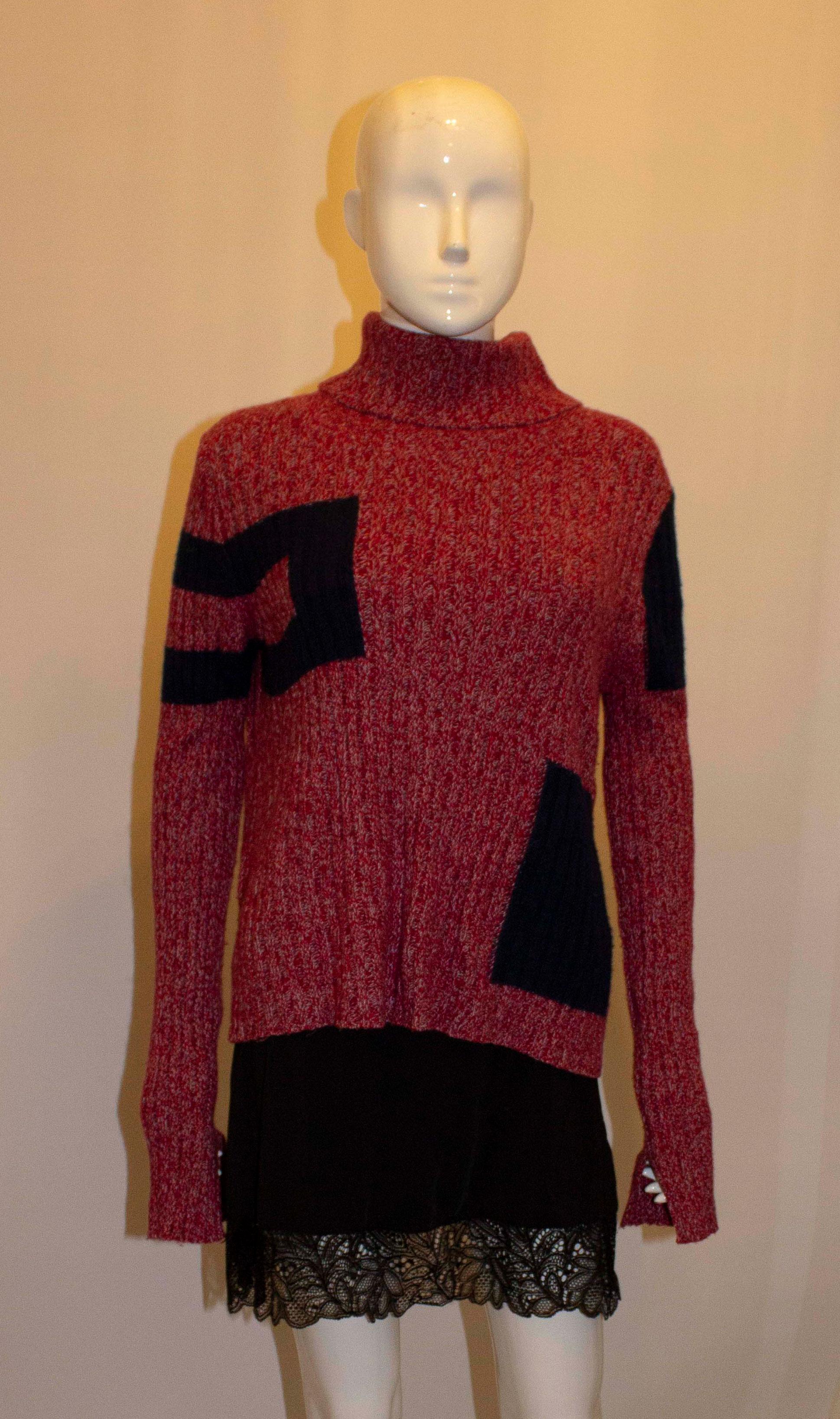 A fun and luxurious jumper by Celine. In a wool, cashmere and silk mix, the jumper has rib detail and blue blocks of colour.  Size M
Measurements: Bust 36'' -40'' length 24''