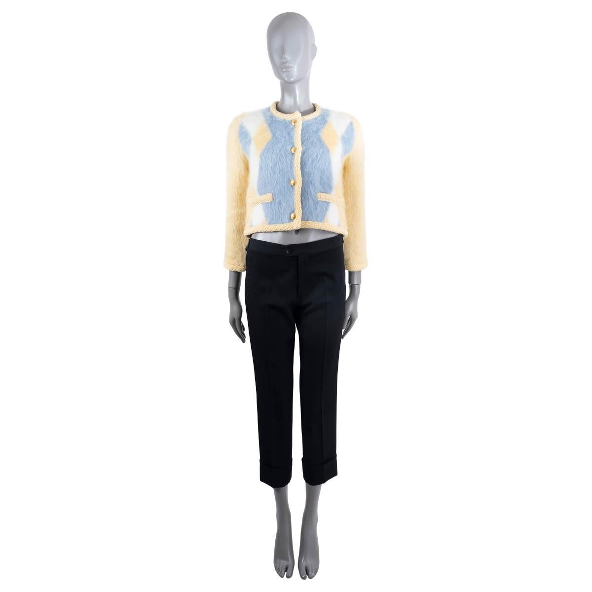 100% authentic Celine Chasseur knit jacket in yellow, baby blue and white brushed mohair (51%), polyamide (31%), wool (14%) and polyester (4%). Features a cropped silhouette, crochet trim in yellow and two slit pockets at the waist. Closes with