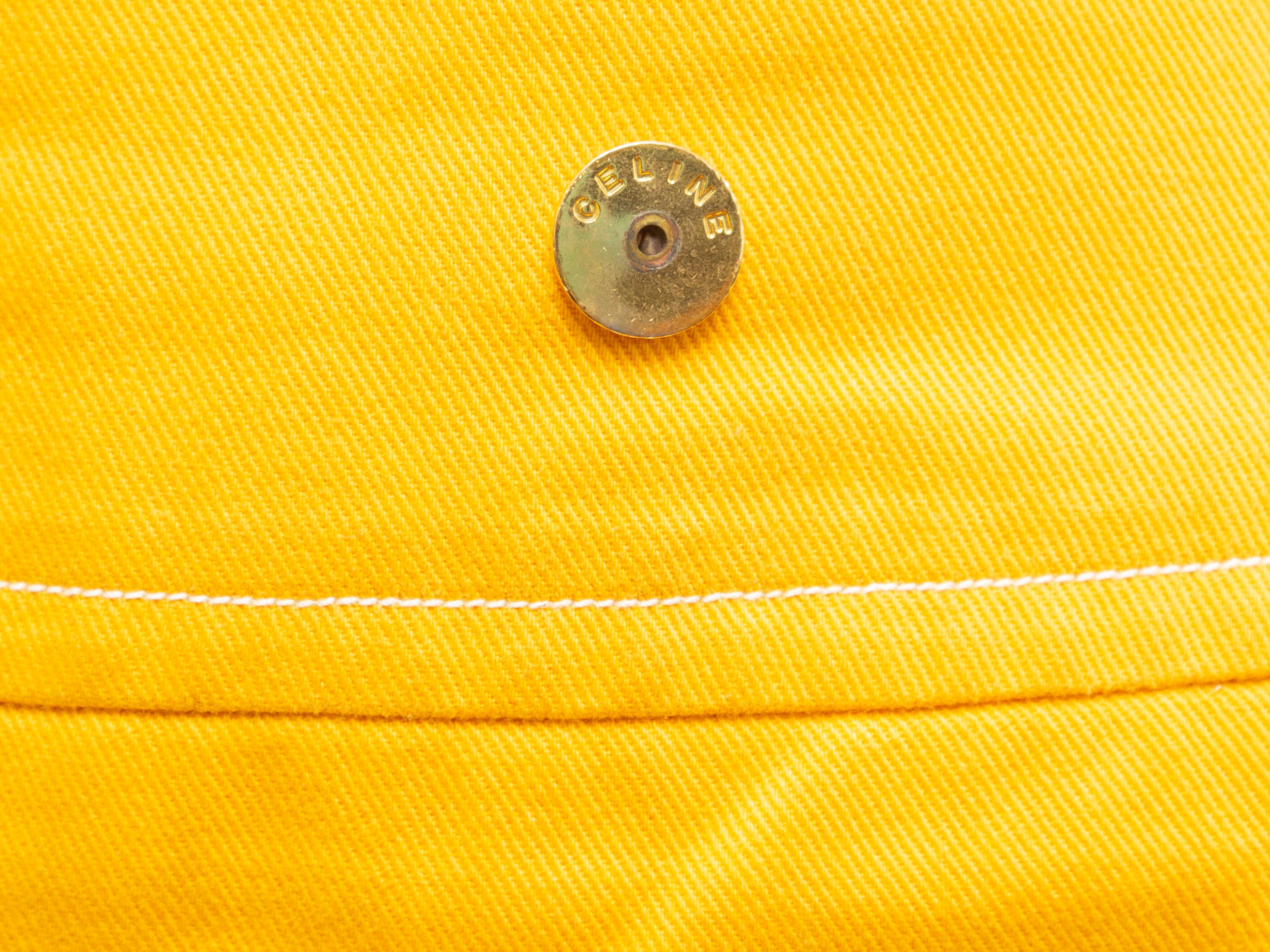 Product details: Vintage yellow denim pencil skirt by Celine. Gold-tone button accents at front waist. Zip closure at center back. 29