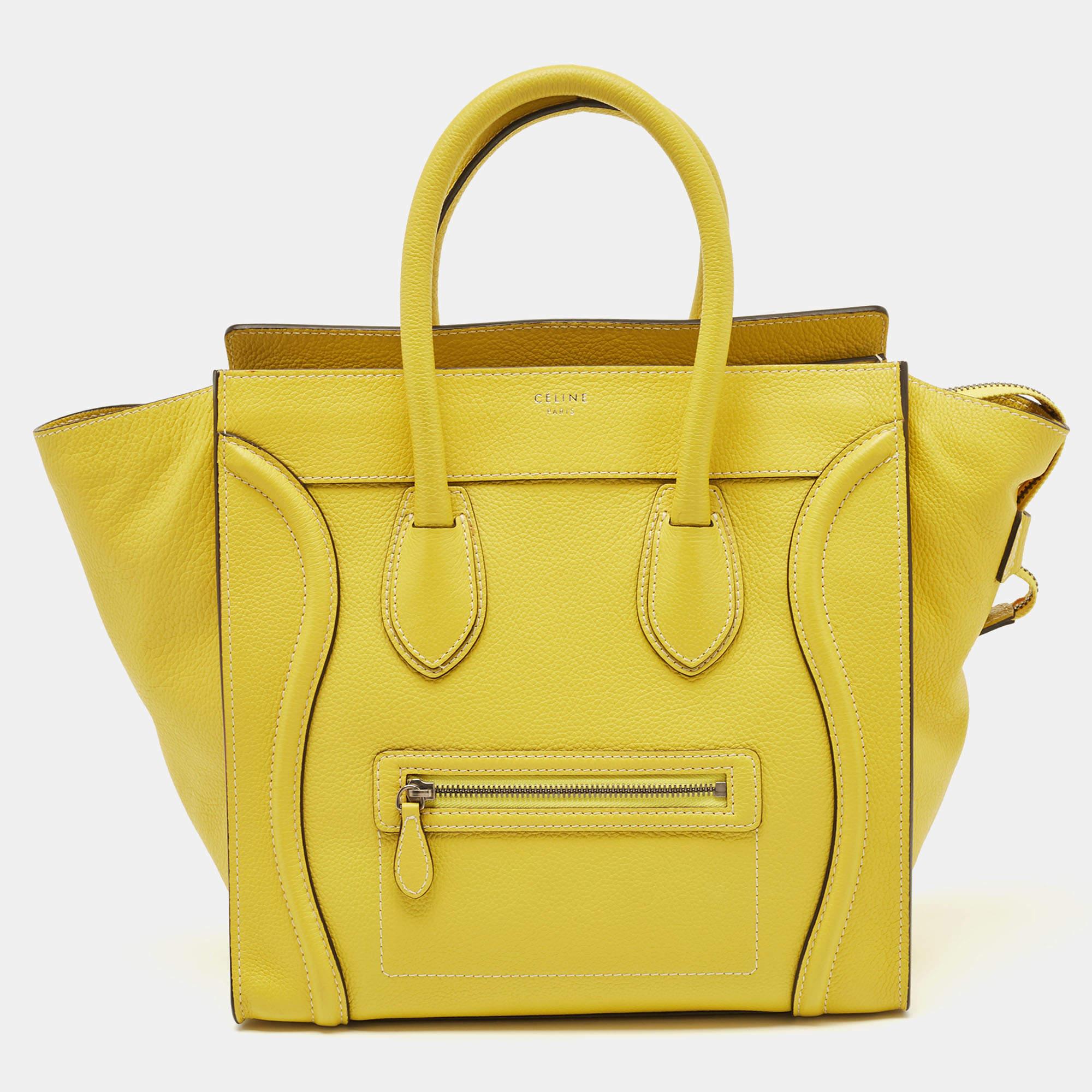 The Céline Luggage tote is a luxurious fashion accessory, featuring a blend of high-quality leather. This compact yet stylish tote showcases a yellow design and is adorned with the discreet Céline logo. It boasts a spacious interior, making it both