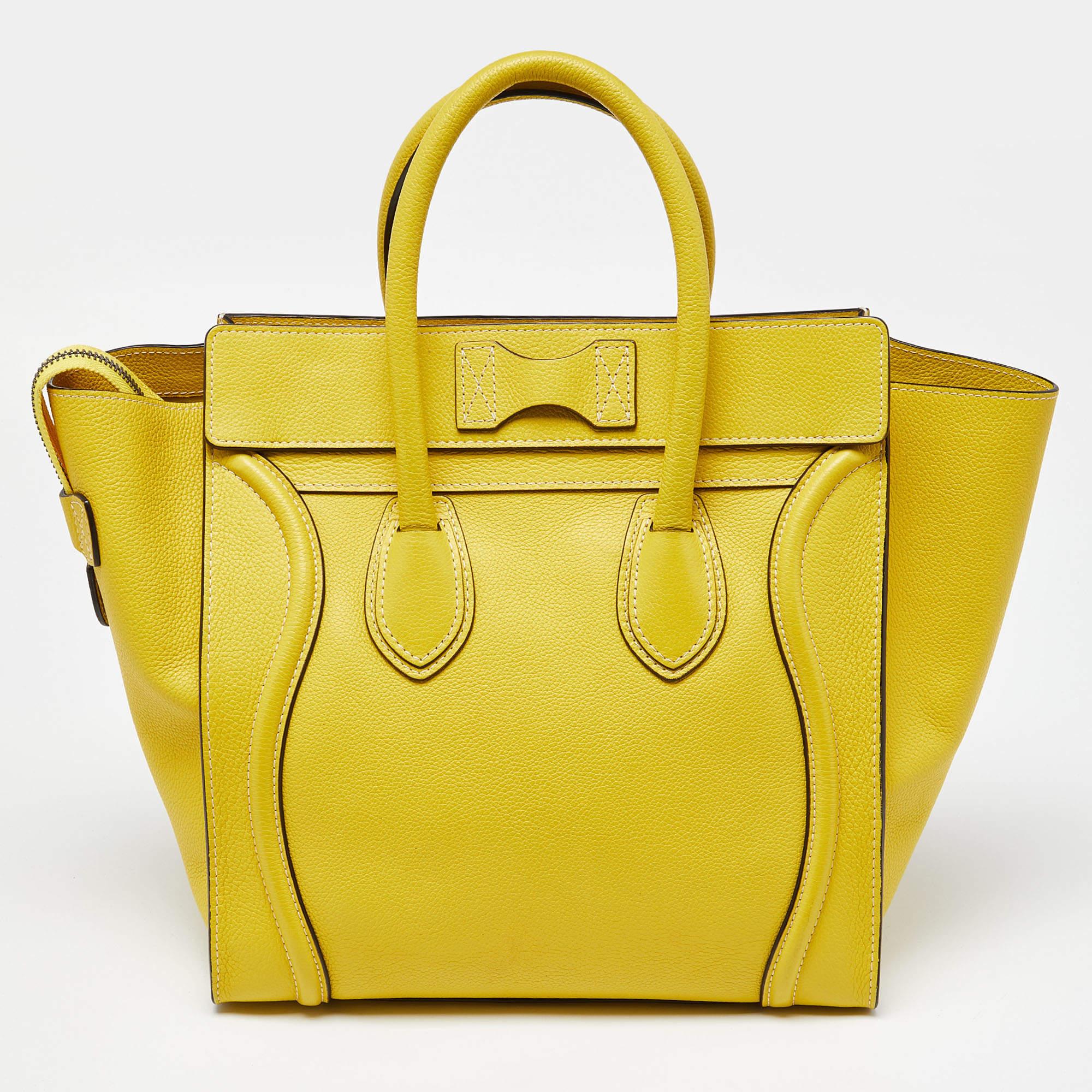 The Céline Luggage tote is a luxurious fashion accessory, featuring a blend of high-quality leather. This compact yet stylish tote showcases a yellow design and is adorned with the discreet Céline logo. It boasts a spacious interior, making it both