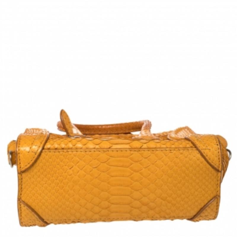 The Nano Luggage tote from Celine is one of the most popular handbags in the world. This tote is crafted from exotic python and designed in a yellow shade. It comes with rolled top handles, a detachable shoulder strap, and a front zip pocket. The