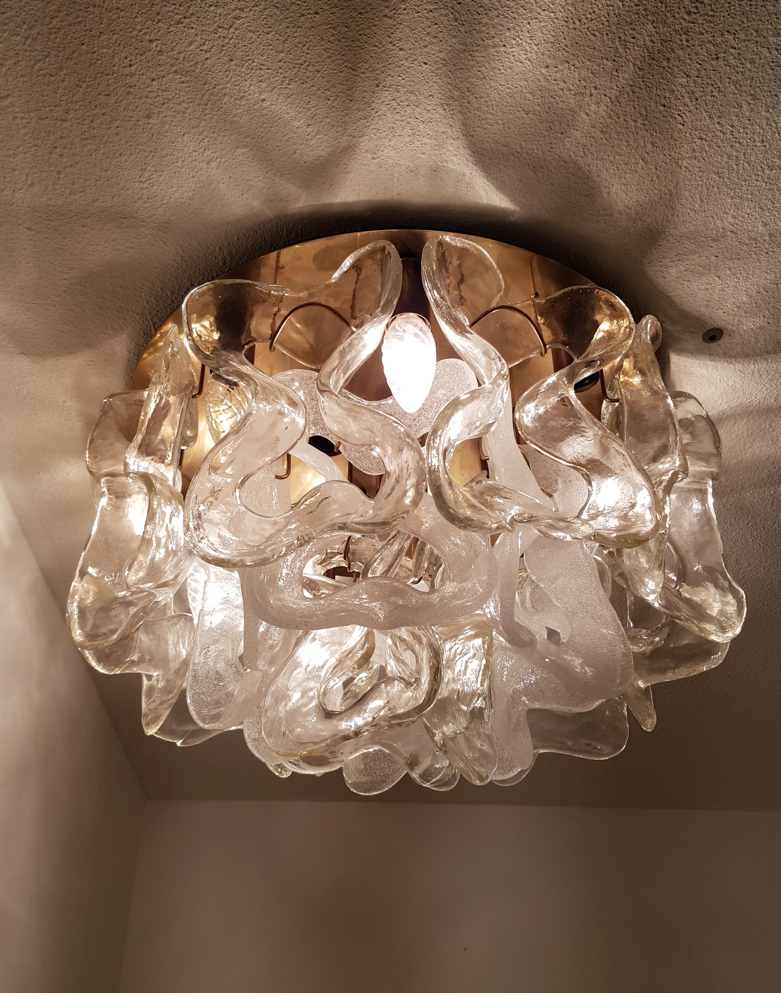 Two ceiling lights, in the style of Kalmar Franken KG in Austria, 1960s.
These identical ceiling lights have a brass circular celling holder and are decorated with 18 large special shaped Murano glass and the inner ring has ice glass and the outer