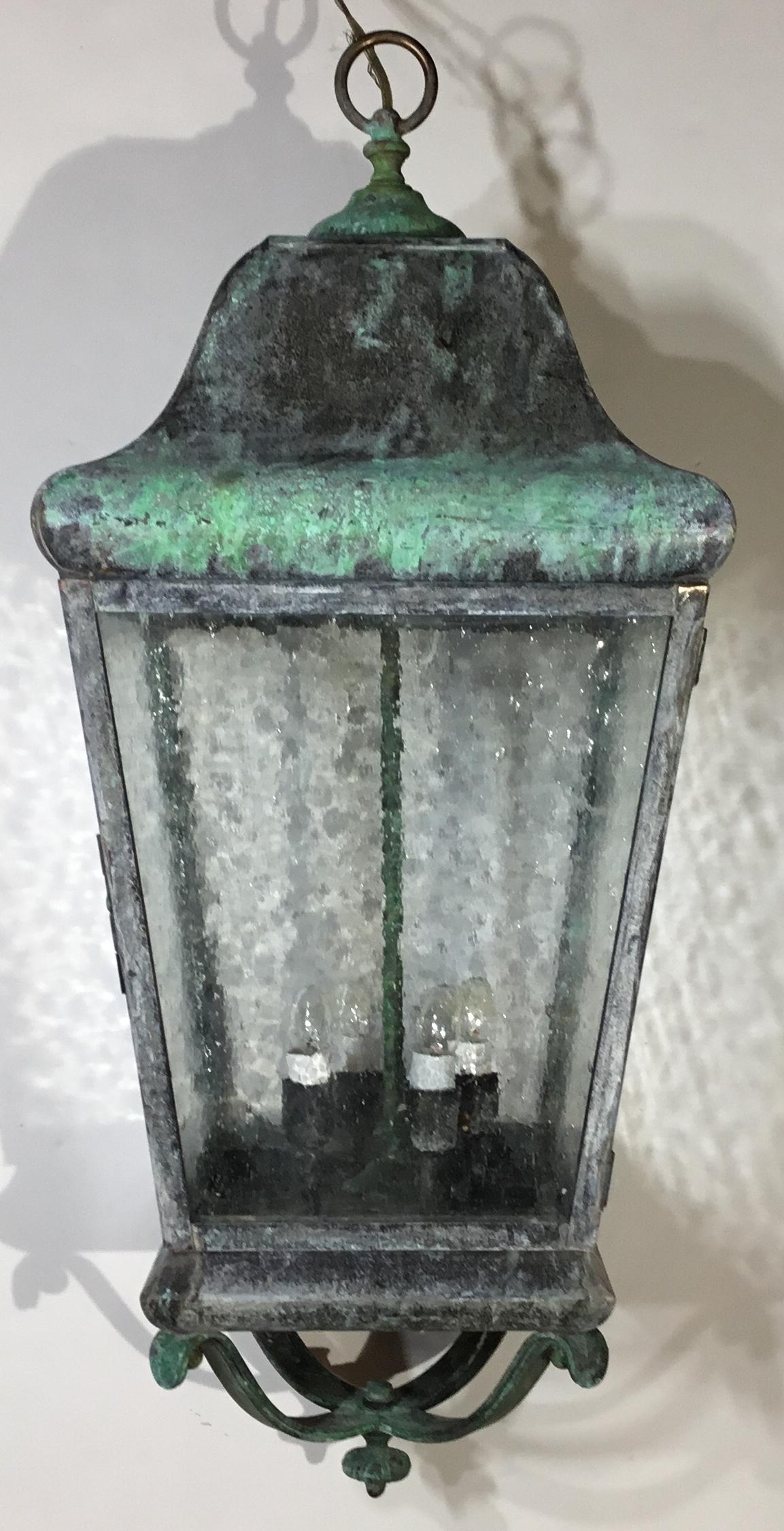 Elegant hanging lantern bade of solid brass and copper, seeded glass, and four 40/watt lights. Suitable for wet locations ready to use, brass canopy included.