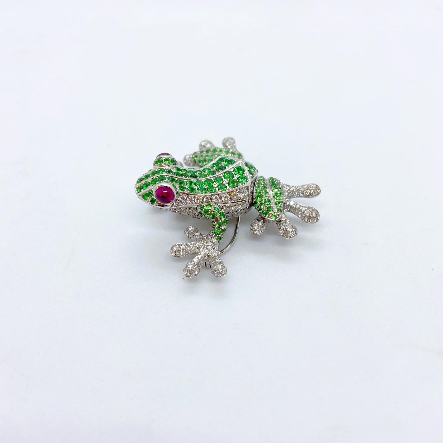 This fun frog brooch is set with 4.40 carats of diamonds , 4.95 carats of tsavorites and has .80 carats of cabochon rubies as eyes. Measurements are 1.75