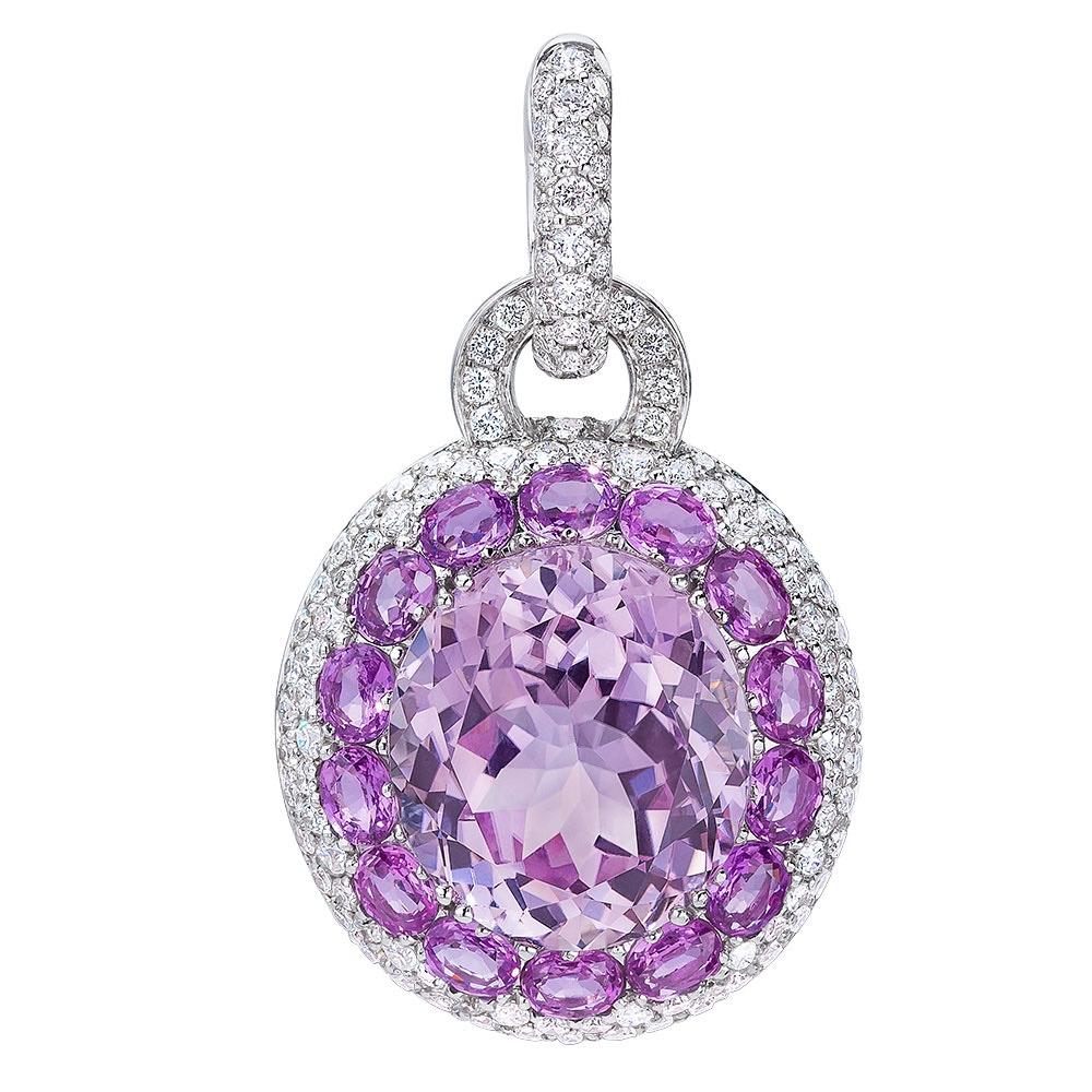 Magnificent Cellini 18 karat white gold drop earrings. The large oval kunzite in the centerpiece of these earrings. The oval kunzite center is framed by round violet sapphires and pave set diamonds that drop from a pave diamond huggie. The back part