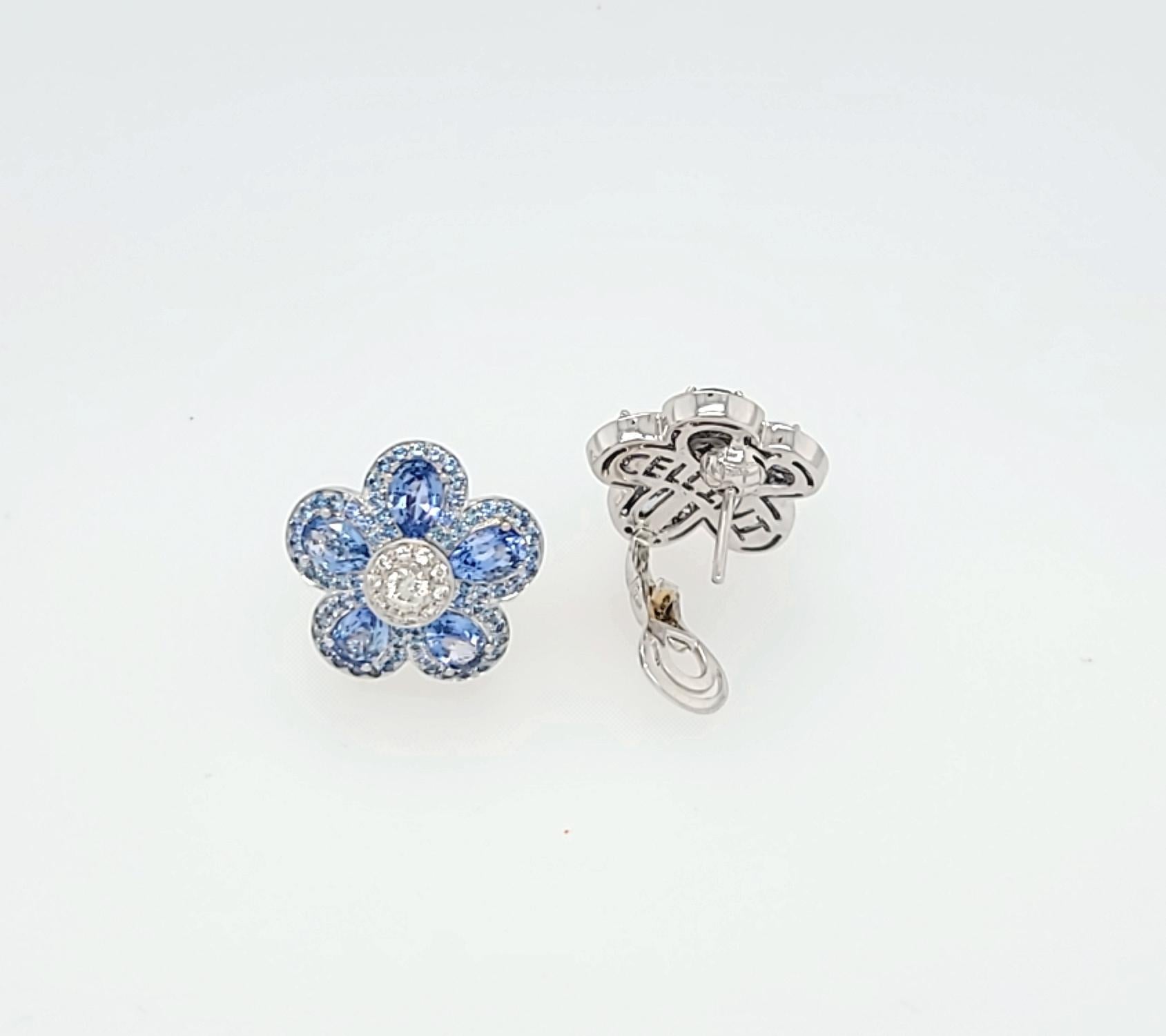 Cellini exclusive sapphire  flower power earrings.
These 18 karat white gold earrings are designed with pear shaped light blue sapphires as petals. Each pear shape is outlined with round light blue sapphires. The Center of the flower is set with a