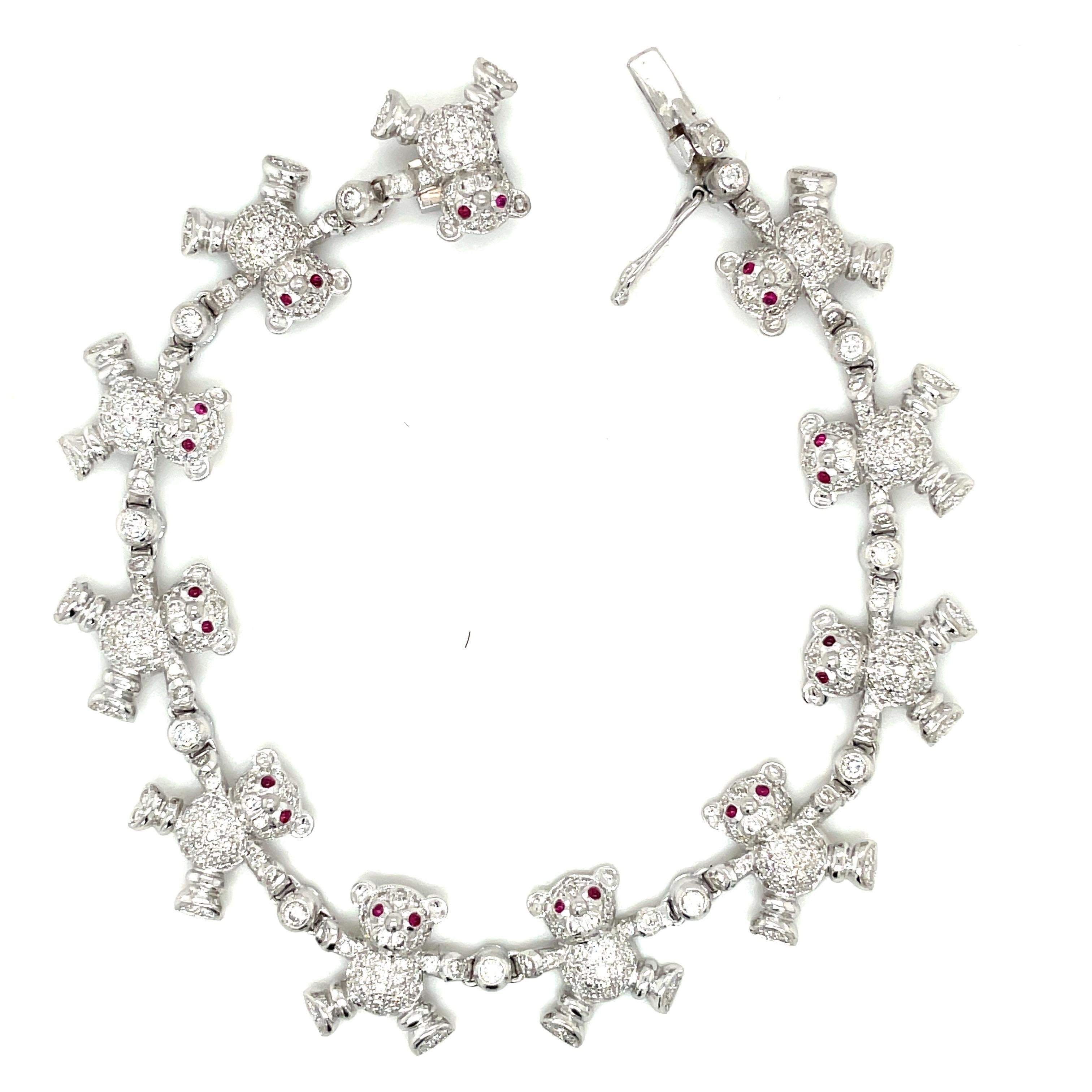 Cellini Jewelers NYC exclusive. A fun and easy to wear diamond bracelet. Designed with 11 pave diamond teddy bears with ruby eyes . Each teddy is joined by a bezel set round diamond. The 18 karat white gold bracelet  measures 7.5