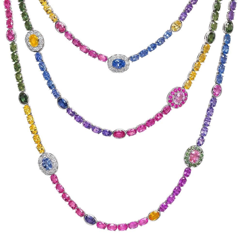 Make a statement wearing this three-row rainbow sapphire necklace. Composed of 149.5 carats of multi-color oval-cut sapphires and accented with 2.07 carats of round brilliant diamonds.
Set in 18-karat white gold.
Length 26