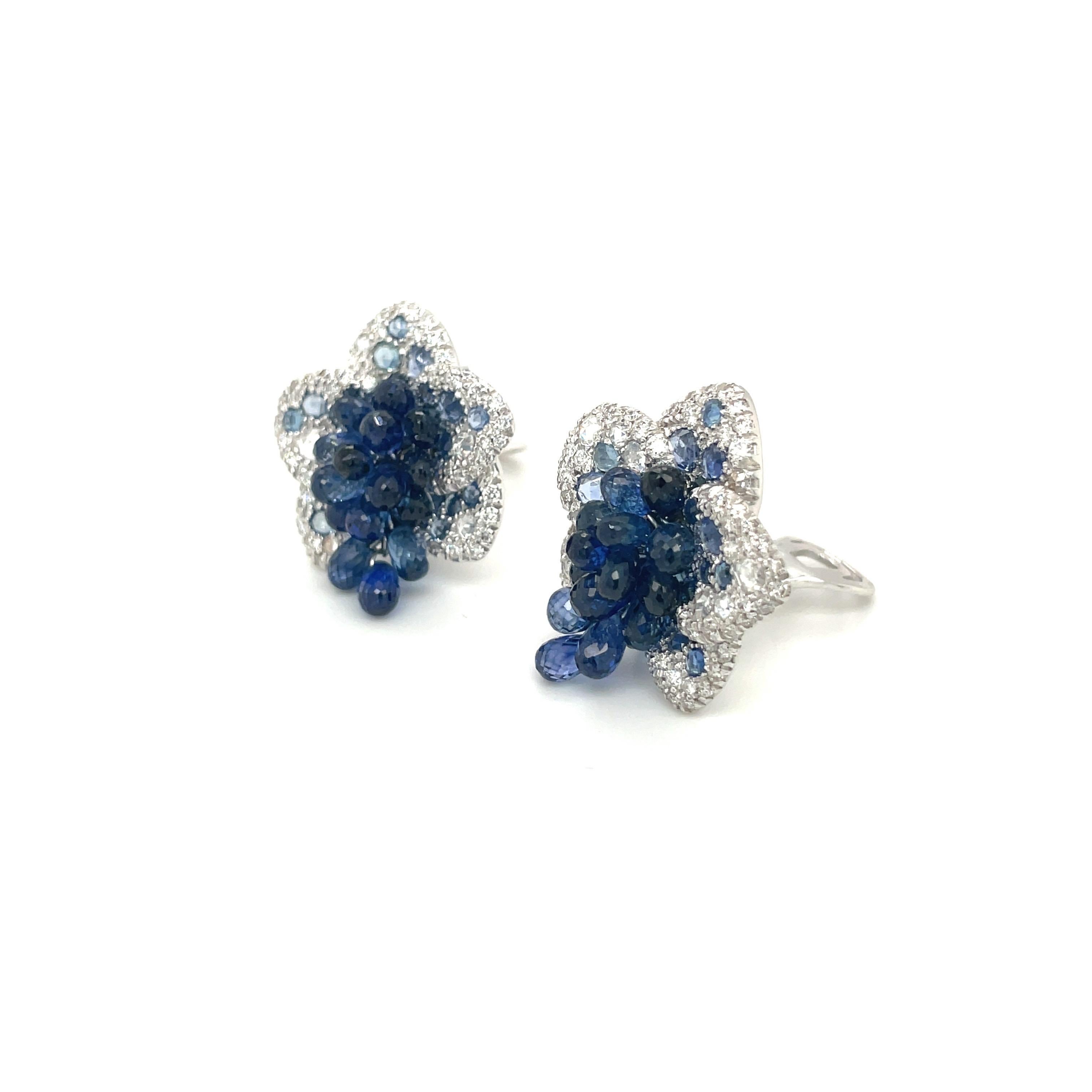 These uniquely stunning 18 karat white gold flower earrings are composed of 1.89 carats of round brilliant and rose-cut diamonds, and 16.72 carats of sapphire briolettes.
The briolette cut allows for the sapphires to dangle and move, allowing them