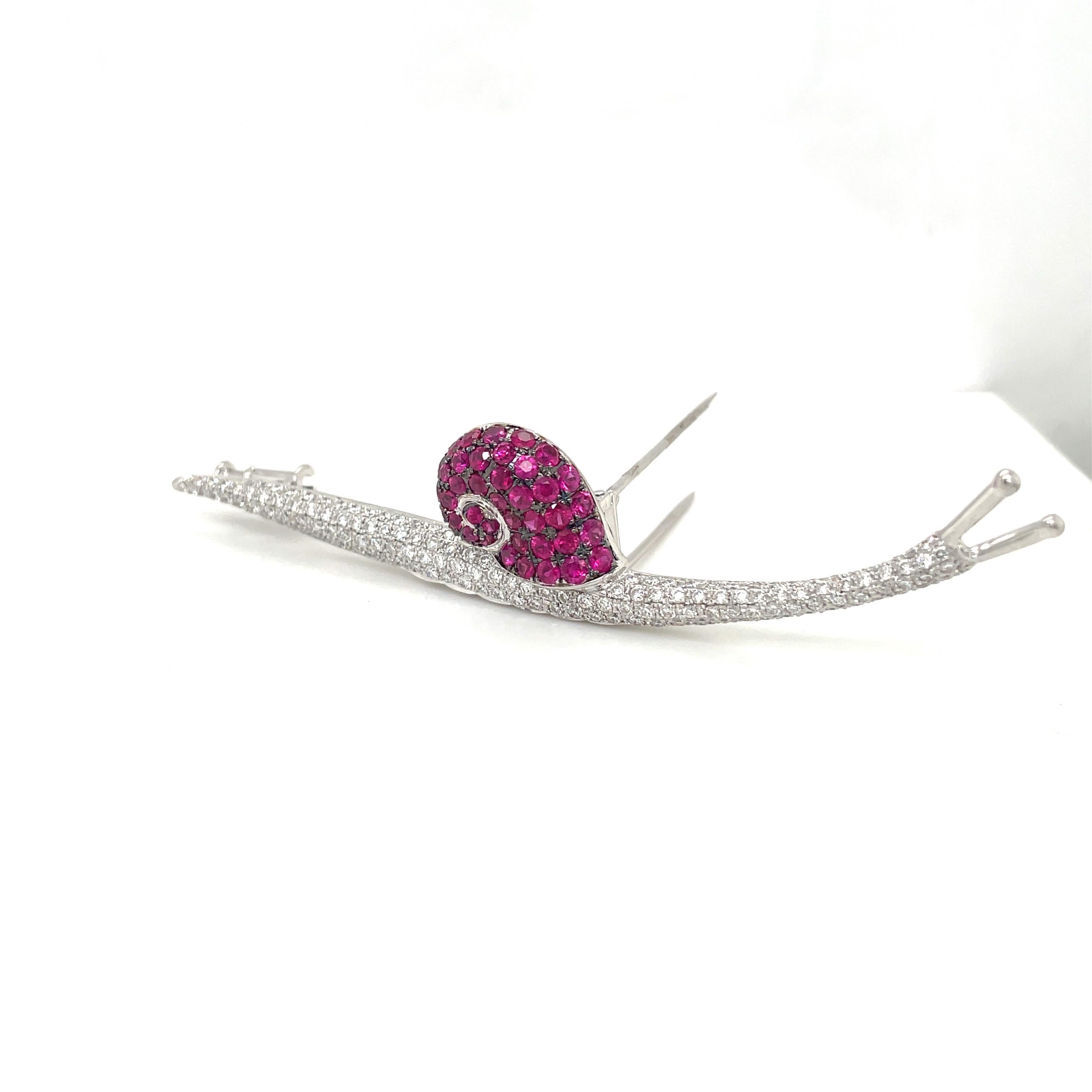 Lovely snail brooch ,artistically designed in 18 karat white gold. The body is set with 1.80 carats of round brilliant diamonds, and the shell is set with 2.50 carats of round rubies. The snail is 3.25