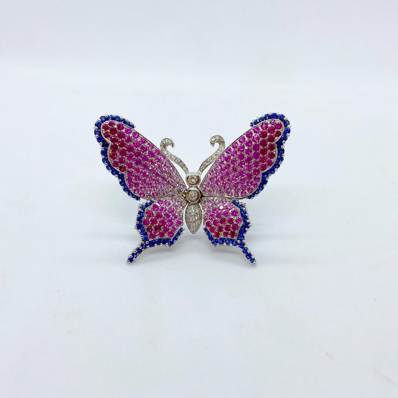 Made exclusively for Cellini NYC ....This lovely 18 karat white gold brooch is set with round brilliant Pink Sapphires. The four wings are trimmed with round brilliant cut Blue Sapphires. The center body and antennae are set with round brilliant