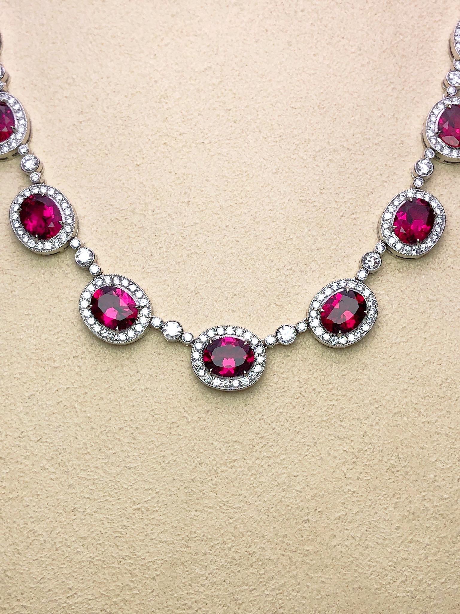Magnificent 18 kart white gold necklace. This necklace is designed with 22 oval cut Rubelites. Each stone is framed with round brilliant Diamonds. Three bezel set round brilliant Diamonds are the connectors. The total length of the necklace is 17.5