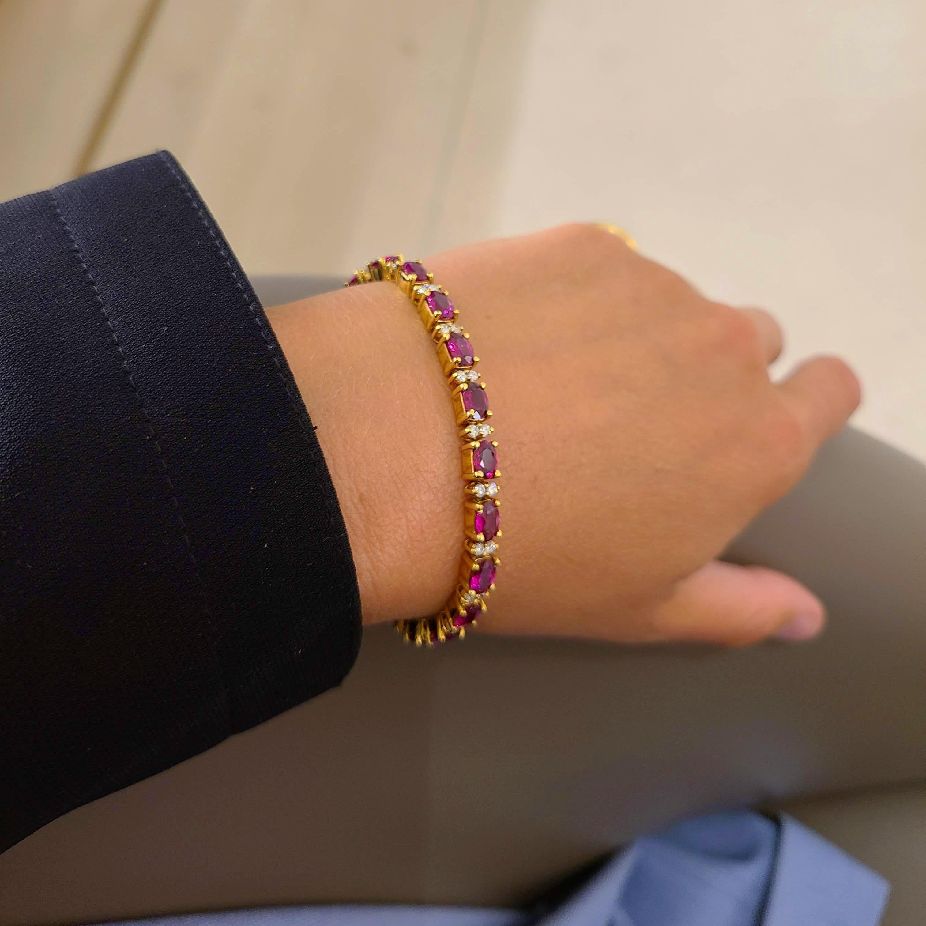 This 18 karat yellow gold bracelet is designed with 21 oval Rubies. Each ruby is set in a 4 prong setting. The Rubies alternate with 2 round brilliant Diamonds also set in 4 prongs. The bracelet measures 7