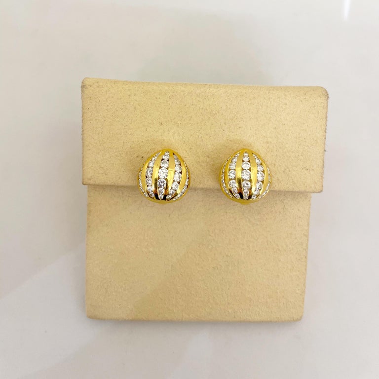 Cute and classic 18 karat yellow gold and diamond earrings. The button style earrings have 5 rows of round brilliant diamonds. The earrings measure 5/8
