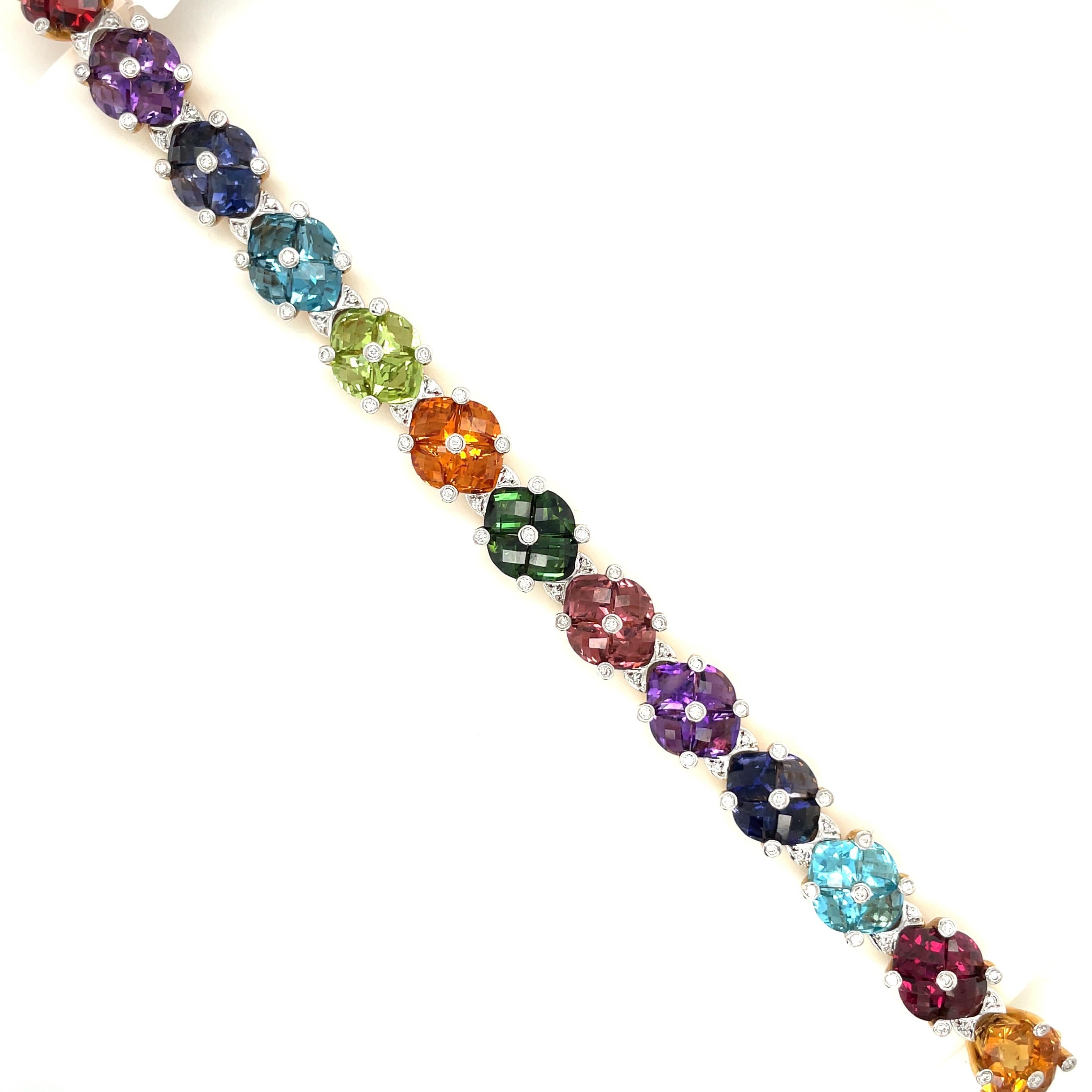 This colorful 18 karat yellow gold and semi precious stone bracelet is designed with 14 cushion shaped sections. Each section is set with 4 briolette cut stones. The semi precious stones are citrine, garnnet, blue topaz, iolite, amethyst, pink and