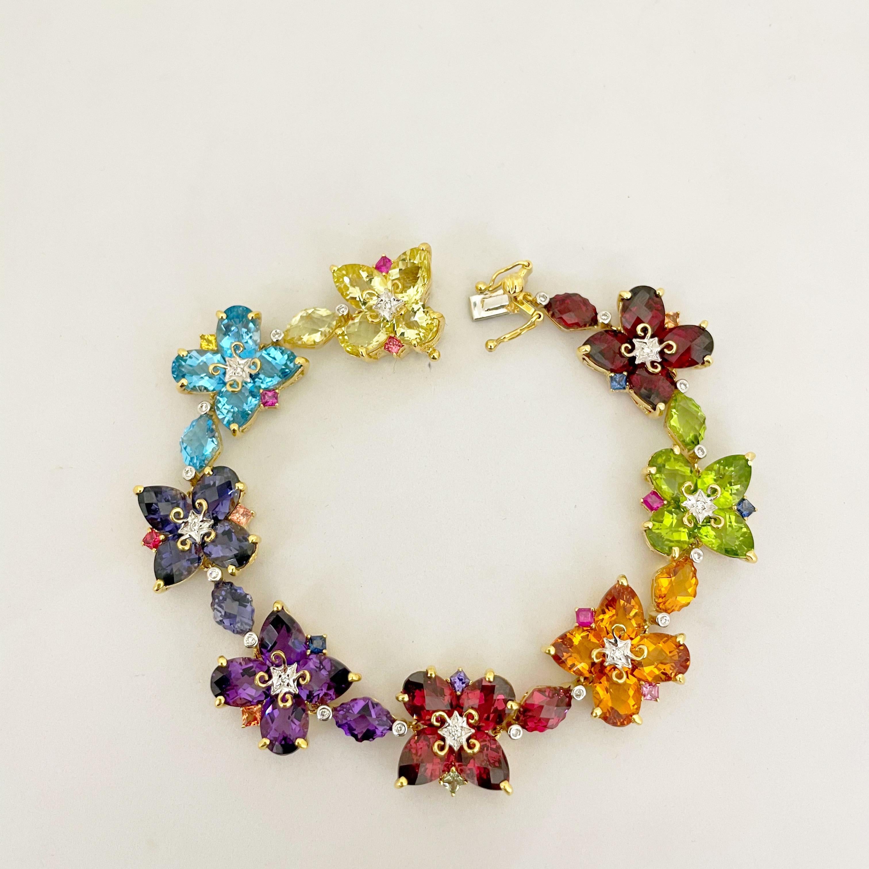 Brighten your day with this colorful semi precious stone bracelet. Eight sections set with lemon quartz, blue topaz, iolite amethyst, pink tourmaline, citrine, peridot and garnet. The sections are designed with 2 oval and 2 pear shaped stones giving