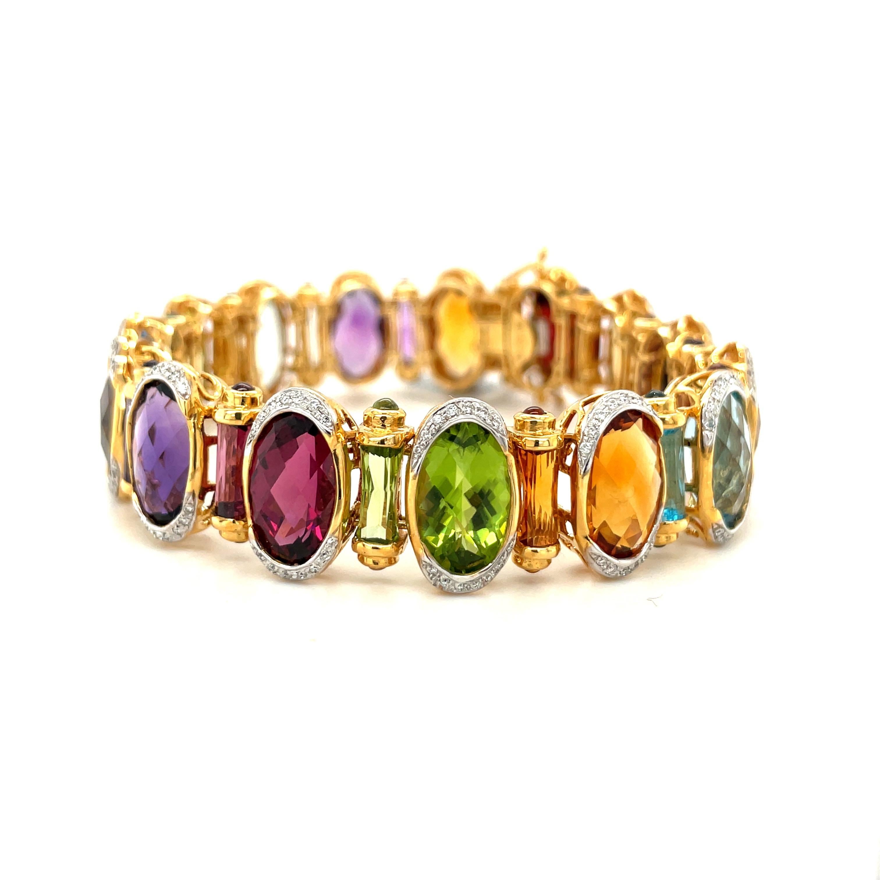 Brighten your day with this amazing Semi Precious colorful bracelet.
The  18 karat yellow gold bracelet is designed with 15 ovals briolette in Blue Topaz, Citrine, Garnet, Amethyst, Lemon Quartz, Peridot ,Pink Tourmaline and Iolite. Each stone is