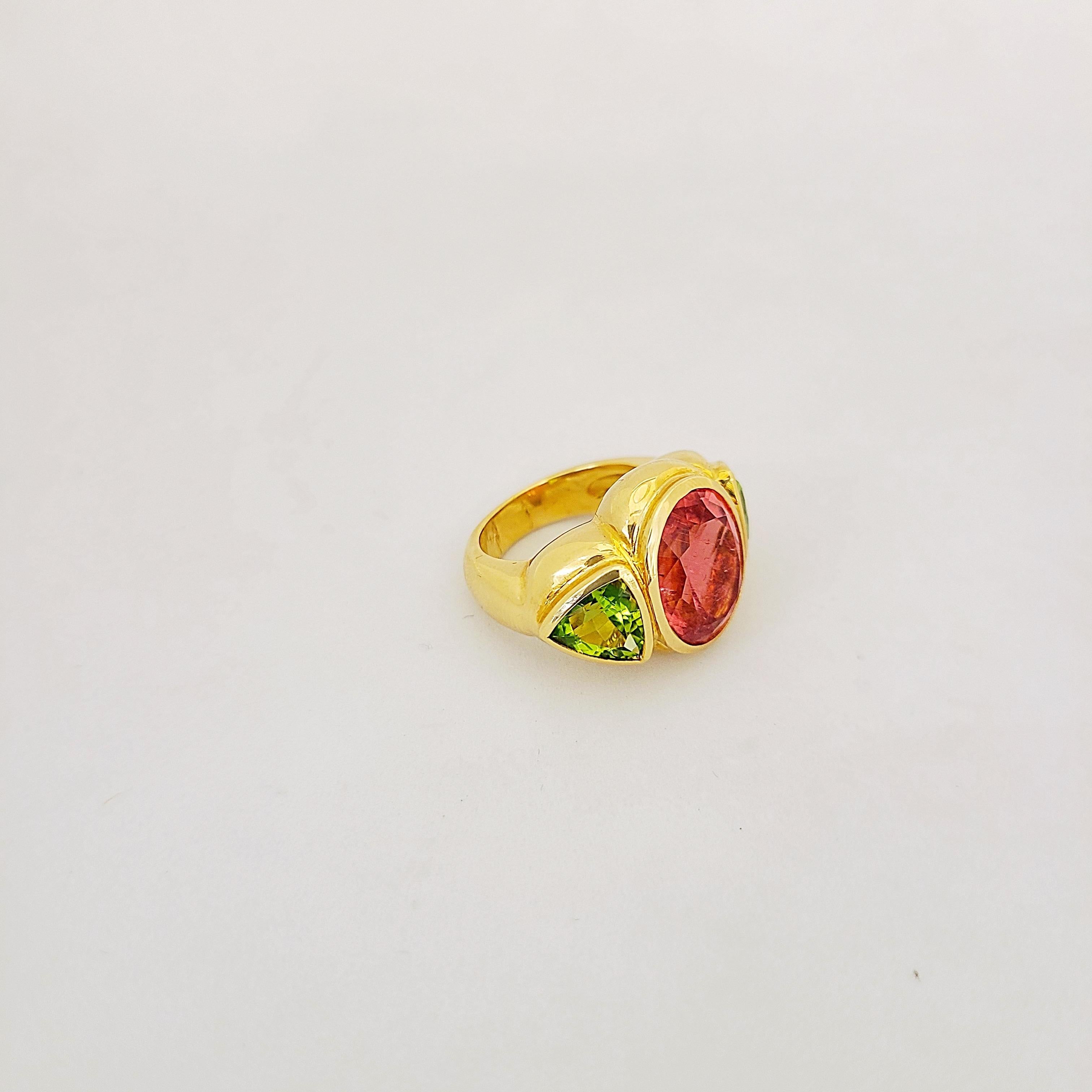 Designed for Cellini this one of a kind ring is set with a oval shaped rubelite center stone flanked by 2  peridot trillion cut stones. Each stone is set in it's own gold bezel in this lovely handmade mounting.
Rubelite total 8.05 carats
Peridot