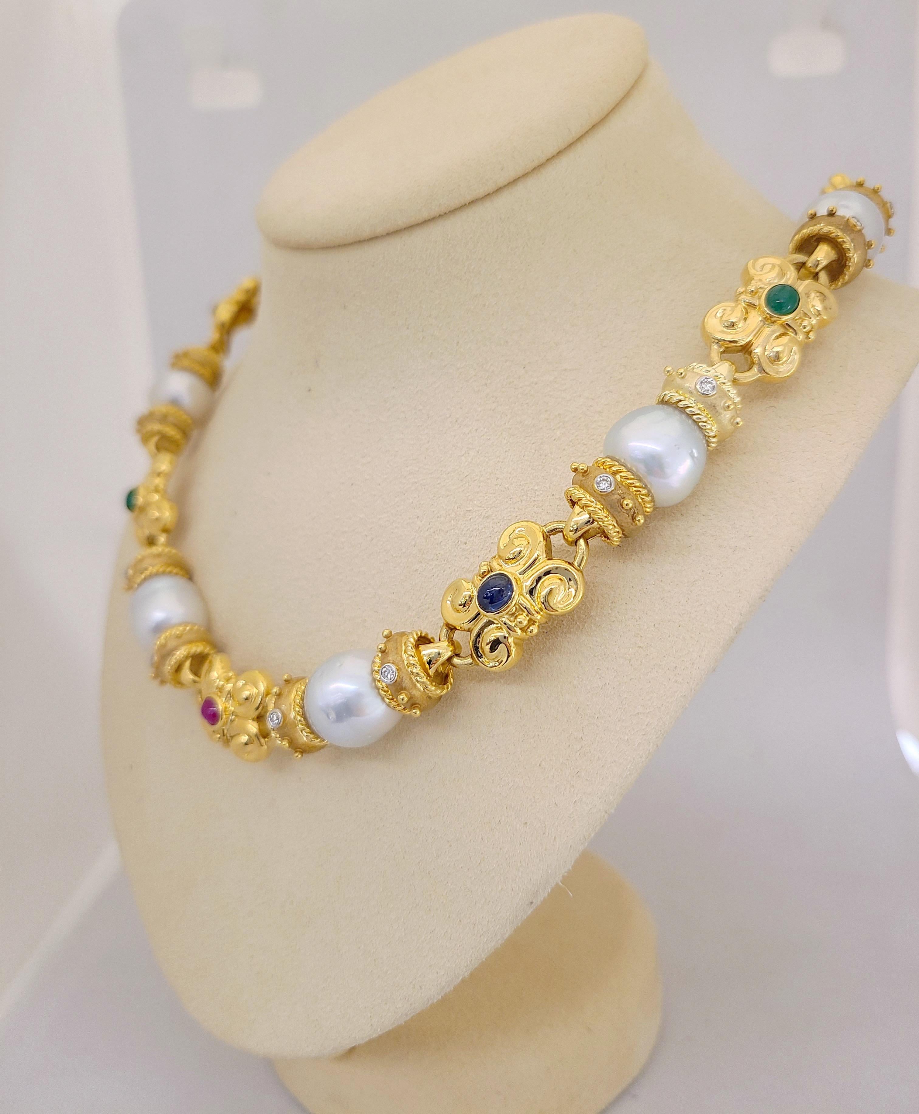A very regal and classic  Cellini Jewelers NYC 18 karat yellow gold  link necklace. Nine links are set with south sea pearls accented with bezel set round brilliant diamonds. The nine alternating links are a scroll motif set with cabochon ruby,