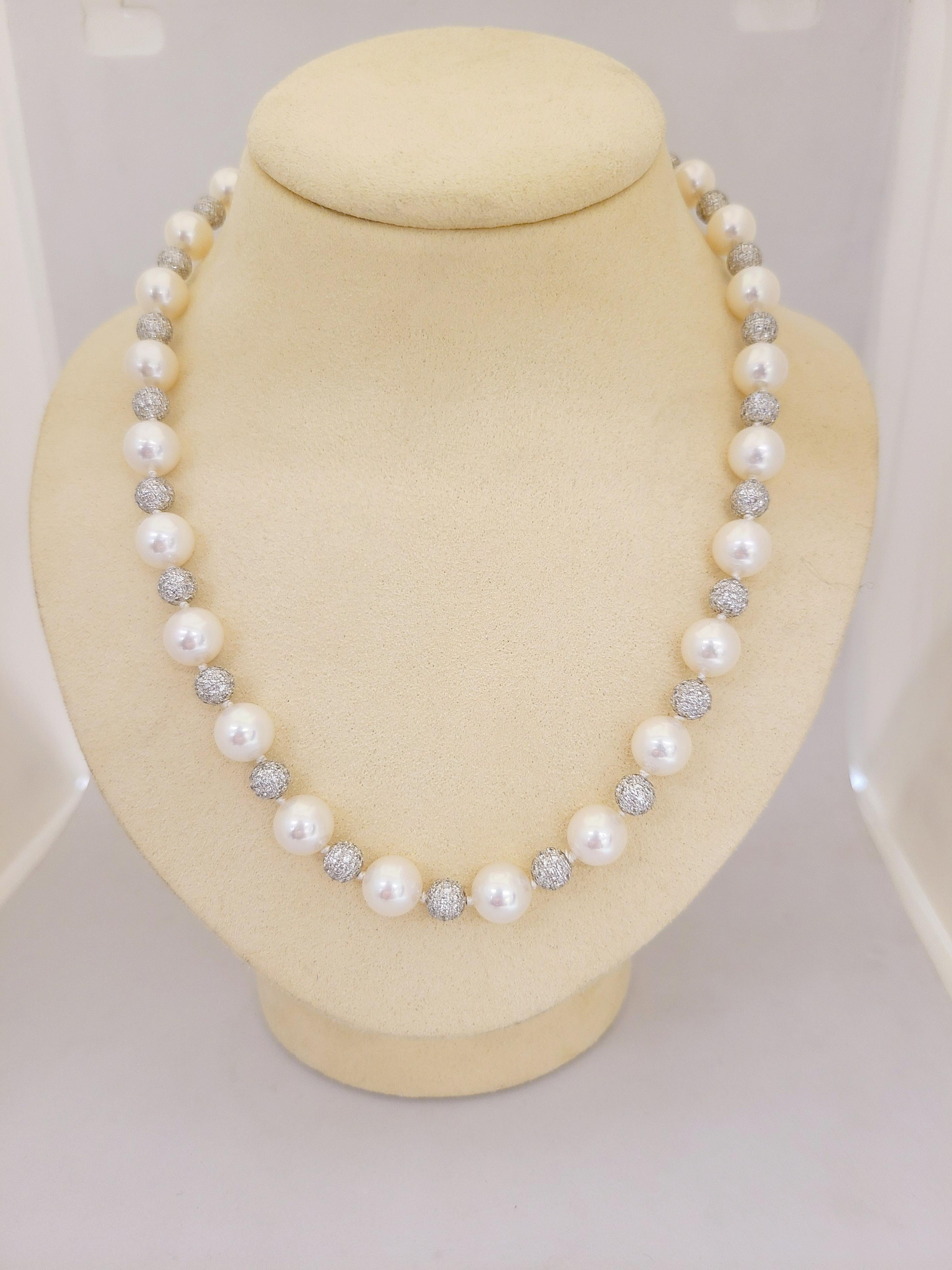 This beautiful Classic pearl and diamond strand necklace by Cellini jewelers NYC. This necklace is composed of 25 cultured 9 mm pearls alternating with 24 white gold pave diamond balls, and a pave diamond ball plunger type clasp.
18 karat white