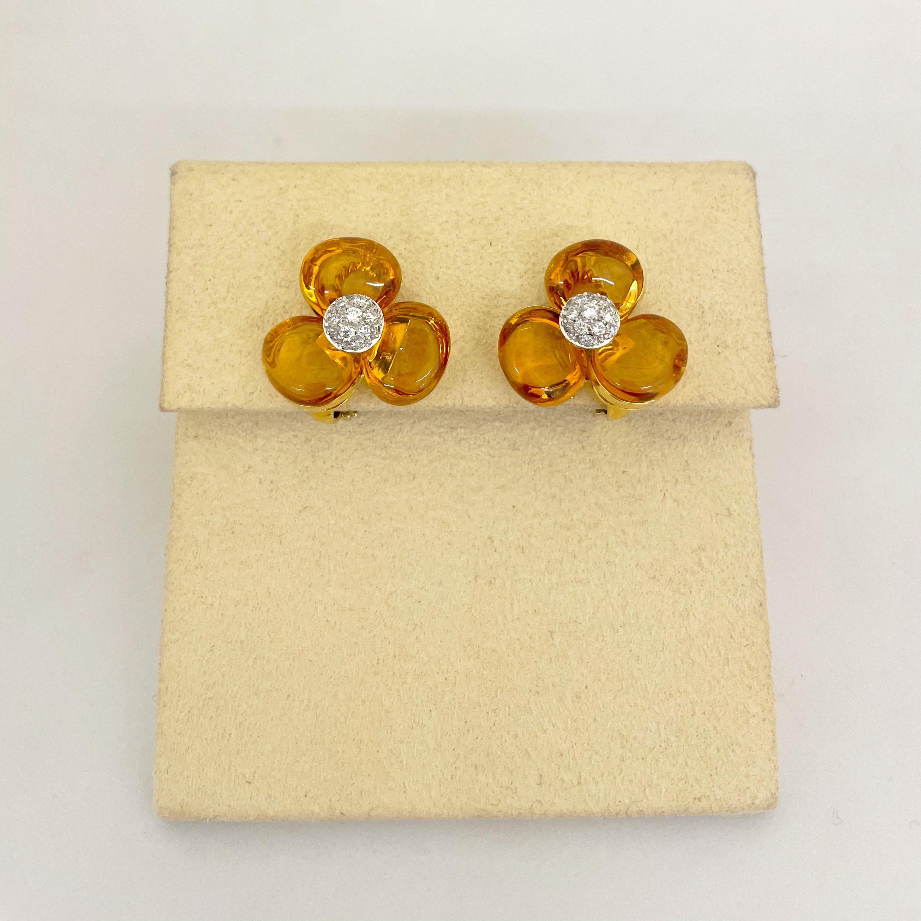 These lovely 18kt yellow gold flower earrings feature 3 beautiful cabochon citrine petals with a pave diamond center, providing just the right amount of sparkle to enhance the natural beauty of the citrine. 
Stamped Cellini 450 Made in Italy 