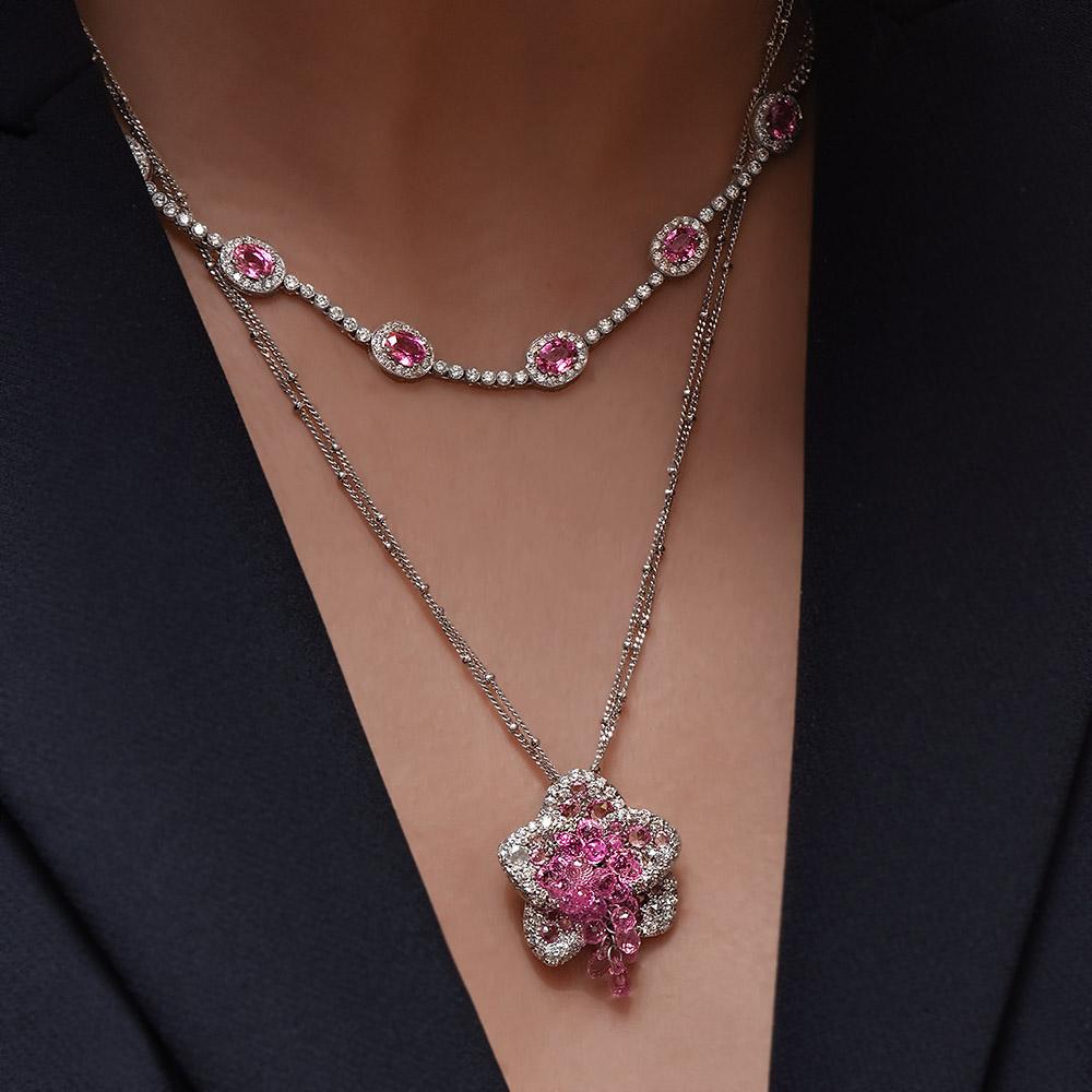 This 18 karat white gold flower pendant was handcrafted in Italy by renowned jewelry designer Verdi exclusively for Cellini Jewelers. The flowers petals are set with rose cut diamonds and rose cut pink sapphires. The center is set with pink sapphire