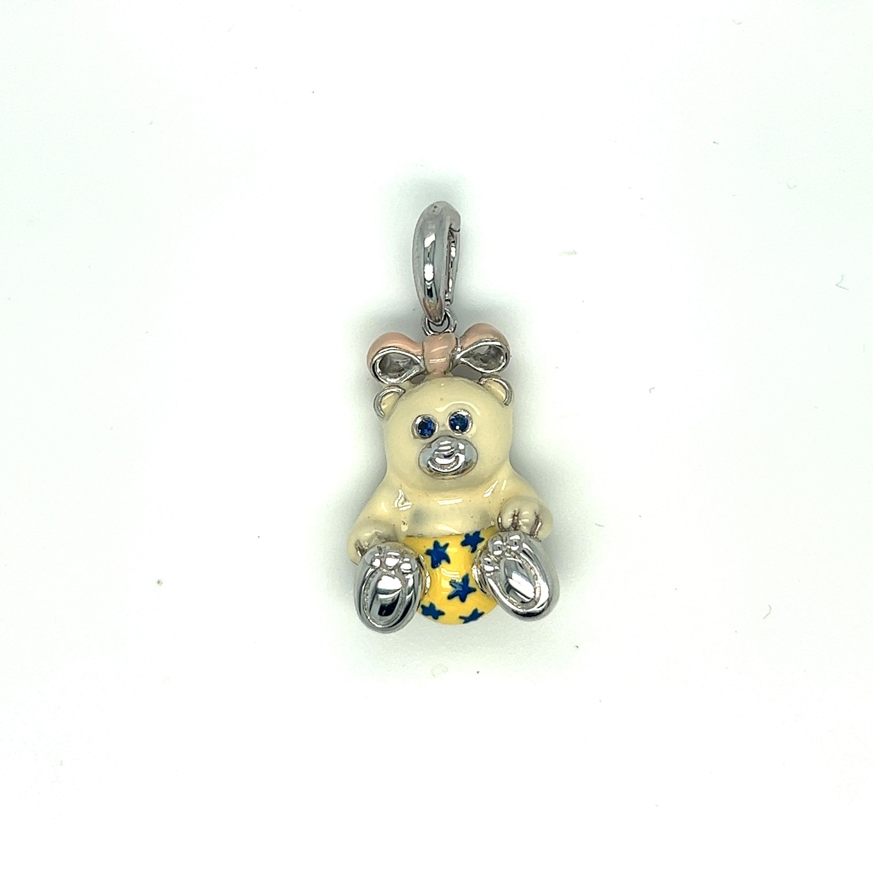 Just the cutest....Teddy bear charm made exclusively for Cellini by Ambrosi of Italy.

This 18 karat white gold teddy bear charm is crafted with a soft white enamel for the body. Her outfit is yellow with blue stars.. She has a pink bow and blue
