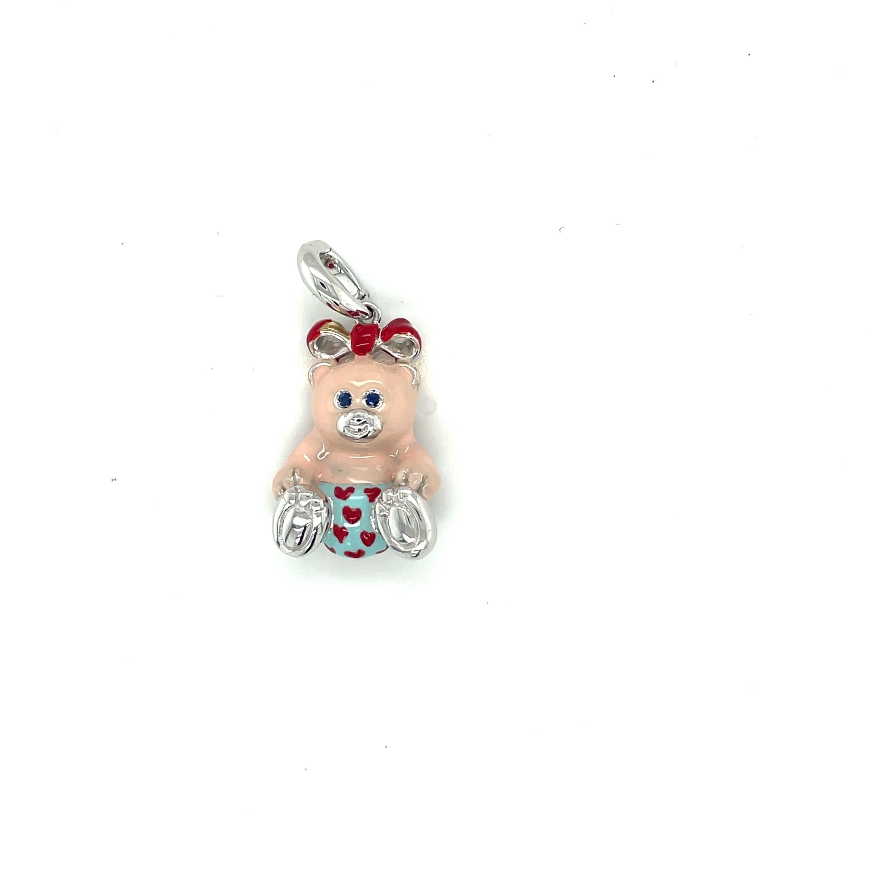 Just the cutest....Teddy bear charm made exclusively for Cellini by Ambrosi of Italy.

This 18 karat white gold teddy bear charm is crafted with a soft pink enamel for the body. Her outfit is light blue with red hearts.. She has a red bow and blue