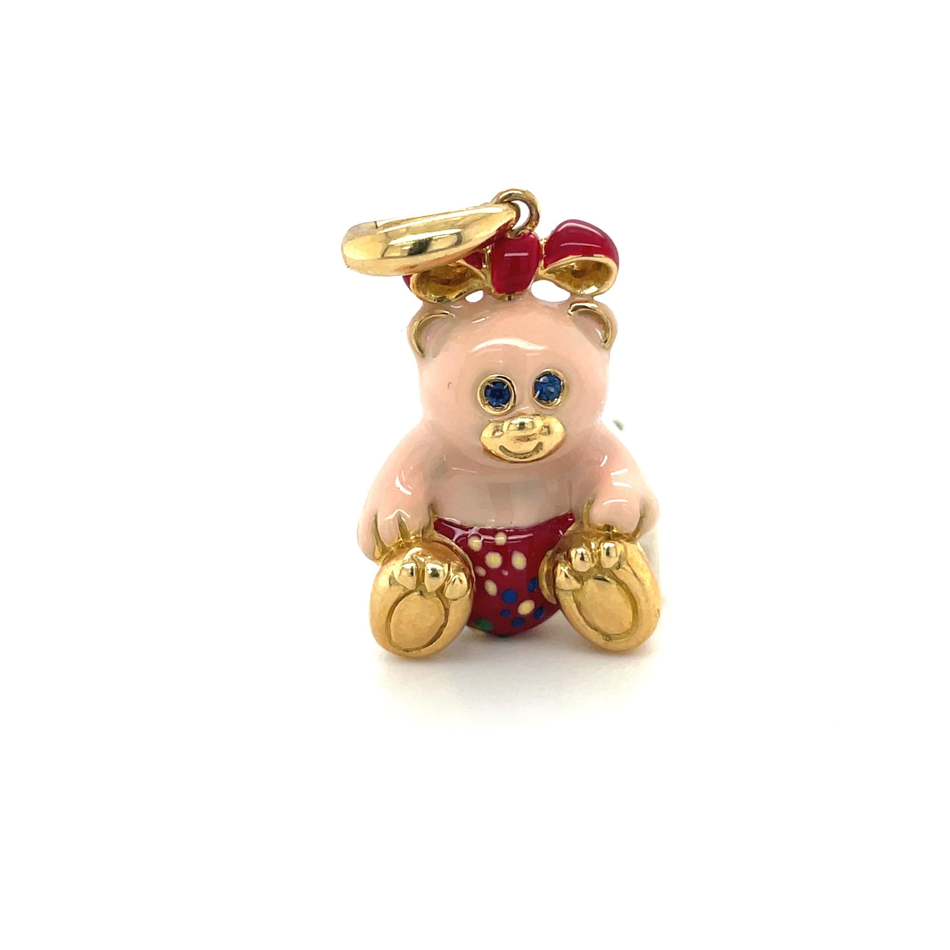 Just the cutest....Teddy bear charm made exclusively for Cellini by Ambrosi of Italy.

This 18 karat yellow gold teddy bear charm is crafted with pink enamel for the body. Her outfit is red with yellow, blue, and green flowers. She has a red bow and