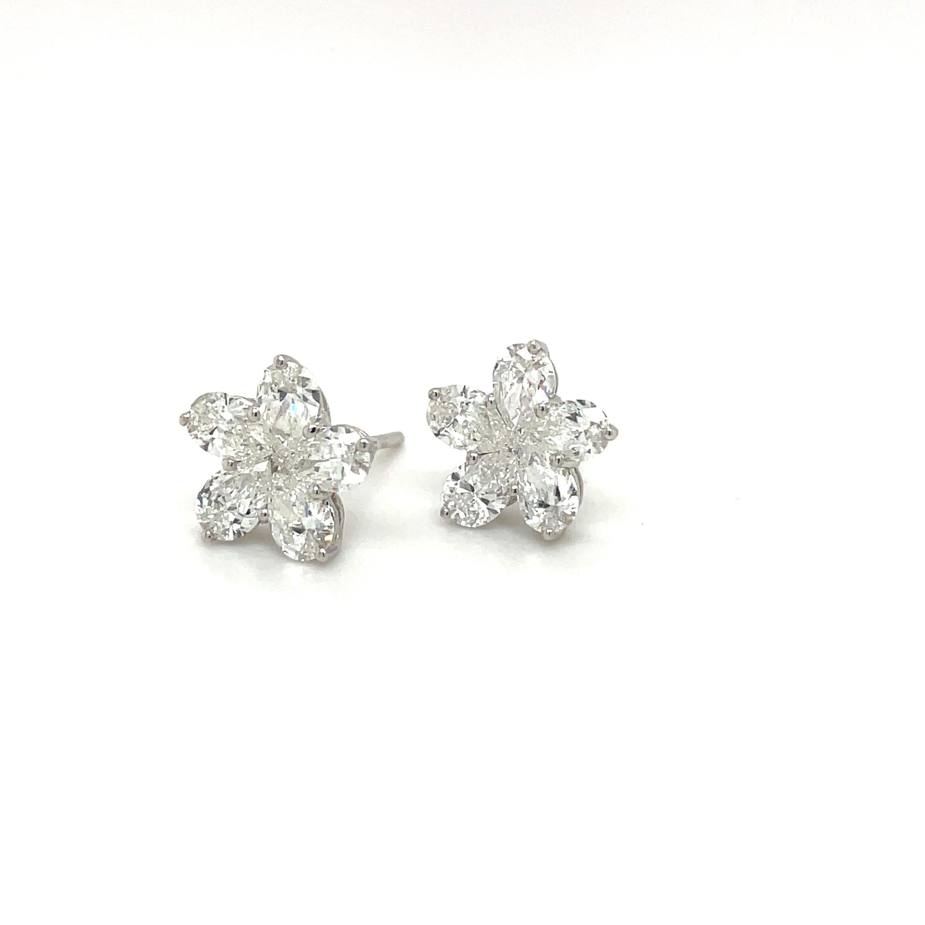 Feminine and elegant is the best way to describe these diamond flower stud earrings. The flower is composed of 5 pear shaped diamond petals and 1 round brilliant diamond in the center .  They are set in  18 karat white gold, with post backs.
10 Pear
