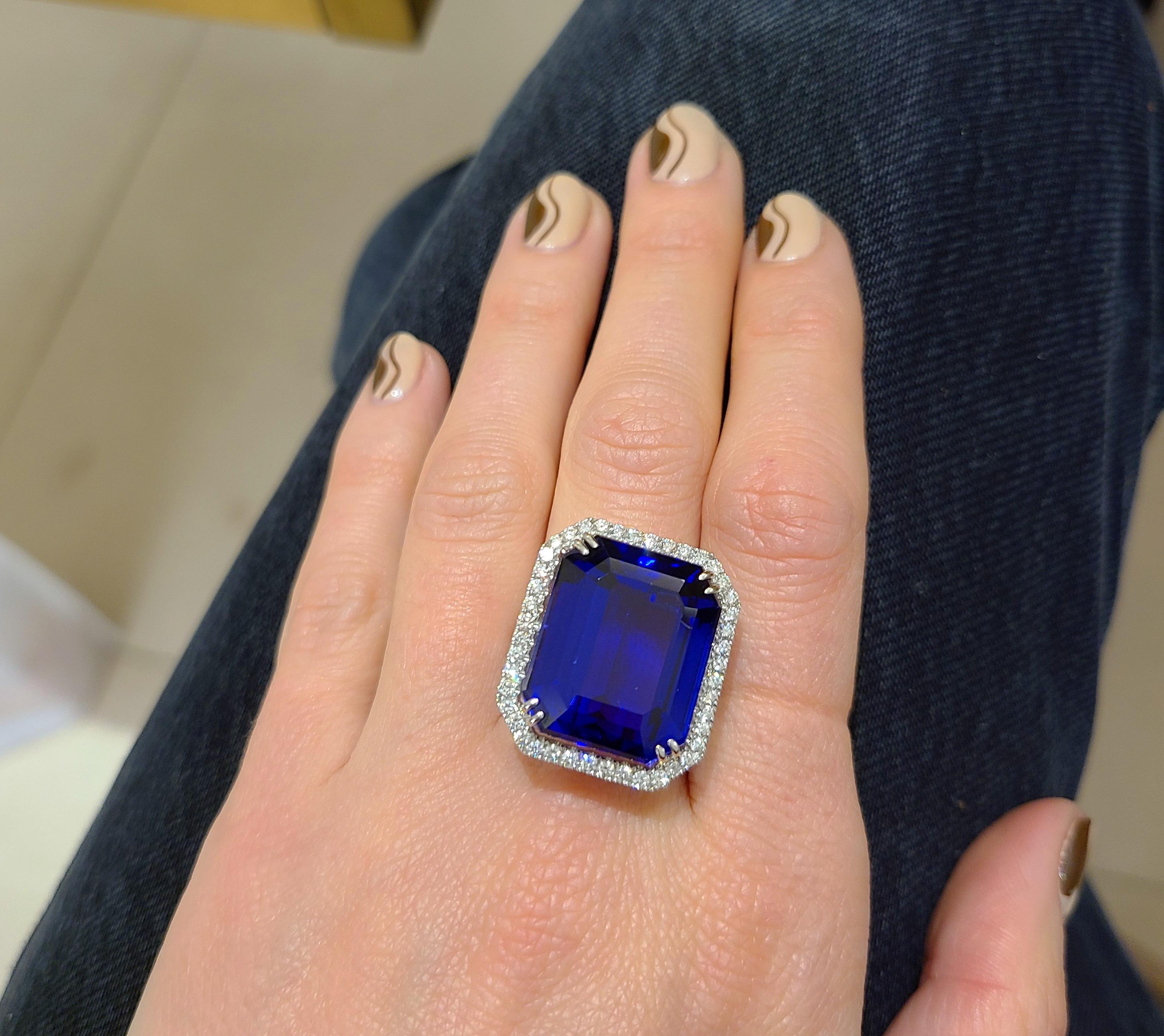 This amazing emerald cut tanzanite center stone ring  is edged with round brilliant-cut diamonds and diamonds along 3/4 of the shank. Set in 18-karat white gold.
Diamond weight: approximately 1.45 carats total.
Tanzanite weight: 32.27 carats.
Ring