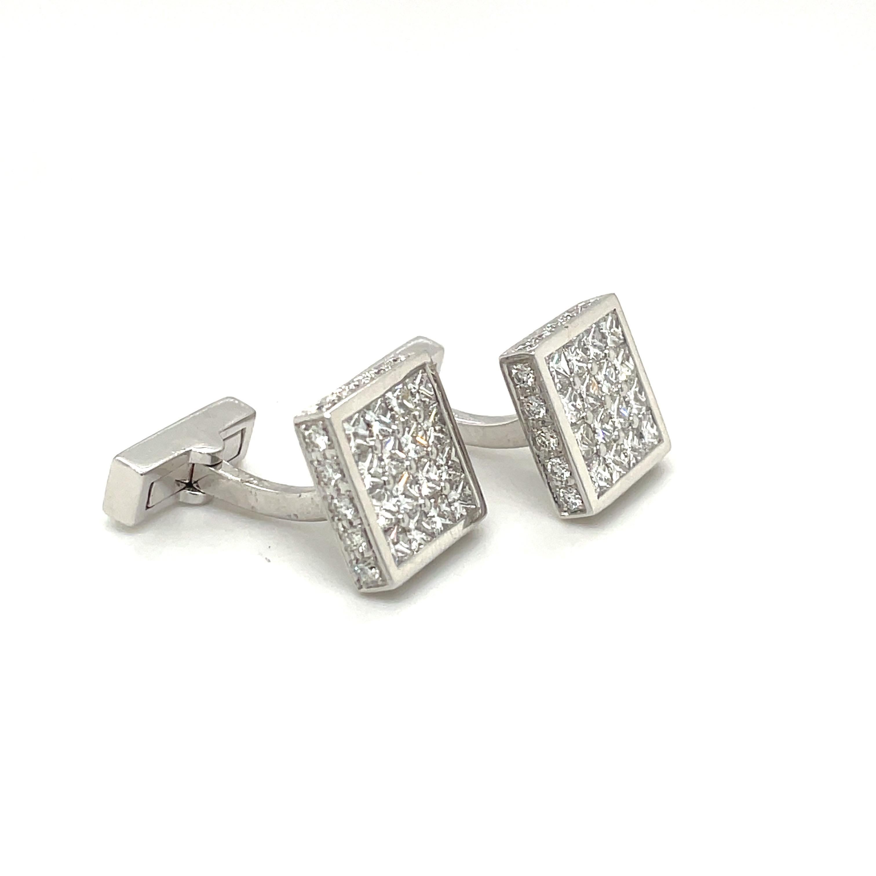 Magnificent pair of 18 karat white gold square diamond cuff links. The cuff links are invisibly set with princess cut diamonds. The entire border of the cuff links are set with round brilliant diamonds. The collapsible bar backs are also set with a