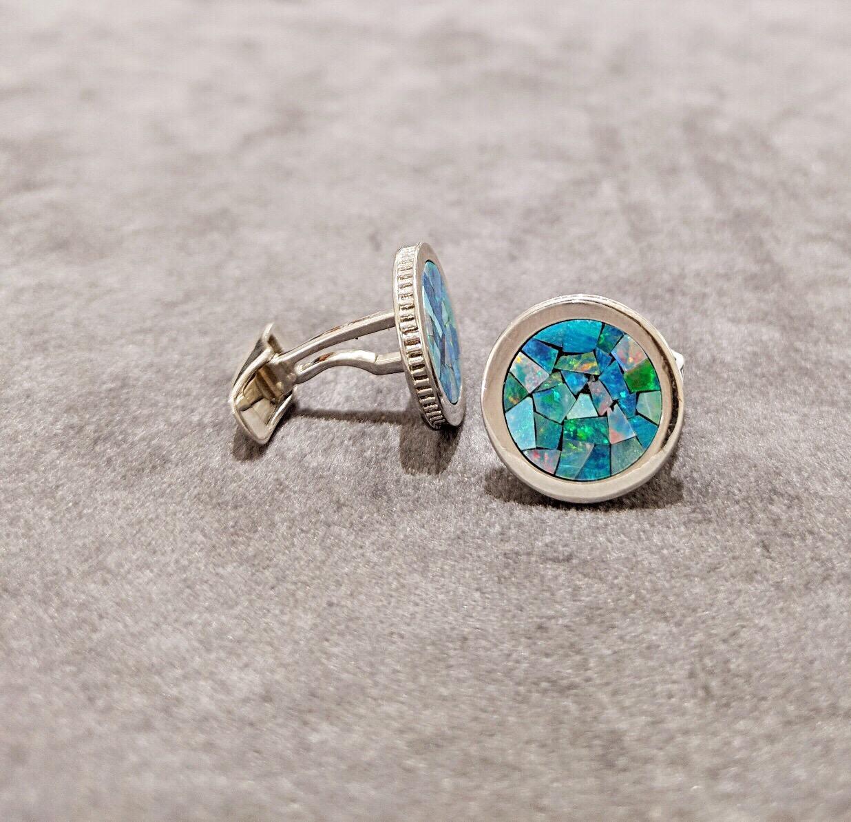 These magnificent 18 kt white gold round cuff links are inlaid with a beautiful opal mosaic pattern. The detailed coin edge further elevates the design. Stamped with the CELLINI logo, these stunning and unique cufflinks are sure to make a