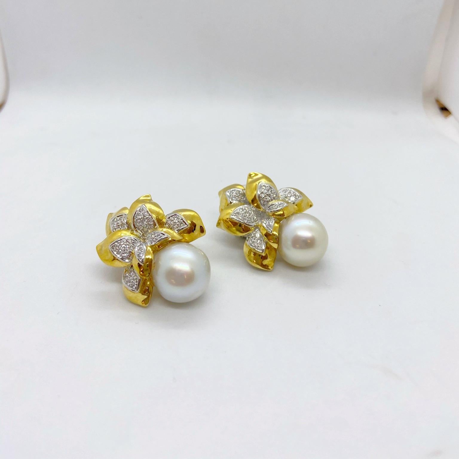 Beautiful ear clips designed in 18 karat yellow gold with hi polished leaves set with pave diamonds. The drop part of the earrings are set with 13mm south Sea pearls. The earrings measure 1-5/8