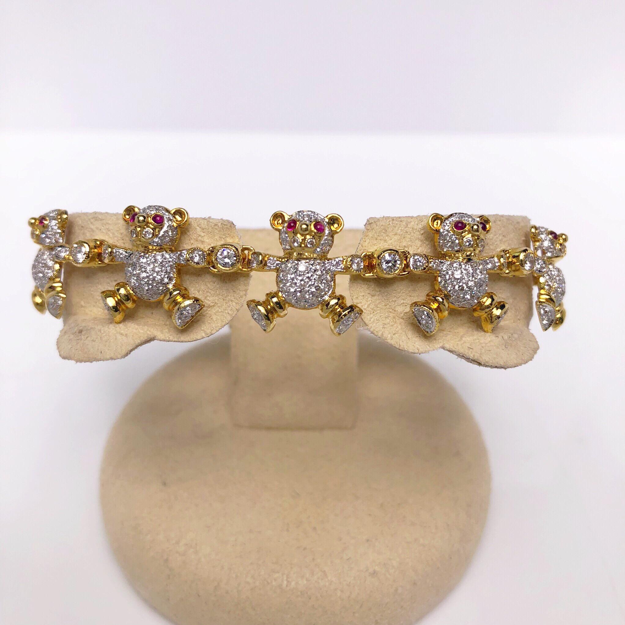 Playful yet elegant best describes this 18KT gold and diamond teddy bear bracelet. Each of the 10 bears are pave set with round white brilliant diamonds and cabachon ruby eyes. They are joined together by round brilliant solitare bezel set