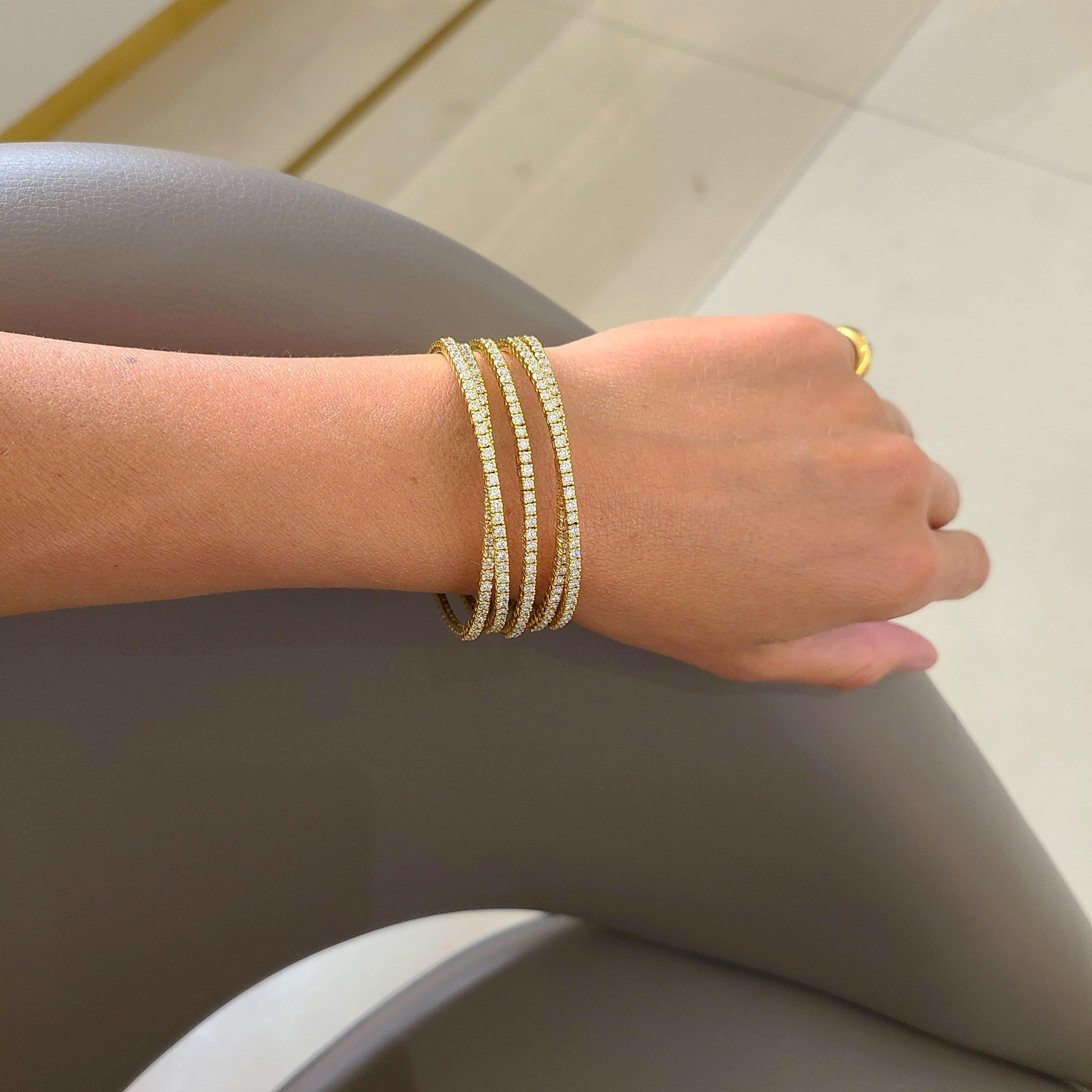 This stunning flexible cuff by Cellini Jewelers NYC is set in 18 karat yellow gold, with 6.72 carats of round brilliant diamonds. The Diamonds are set in five flexible rows which span three quarters around the wrist, making this bracelet an easy to