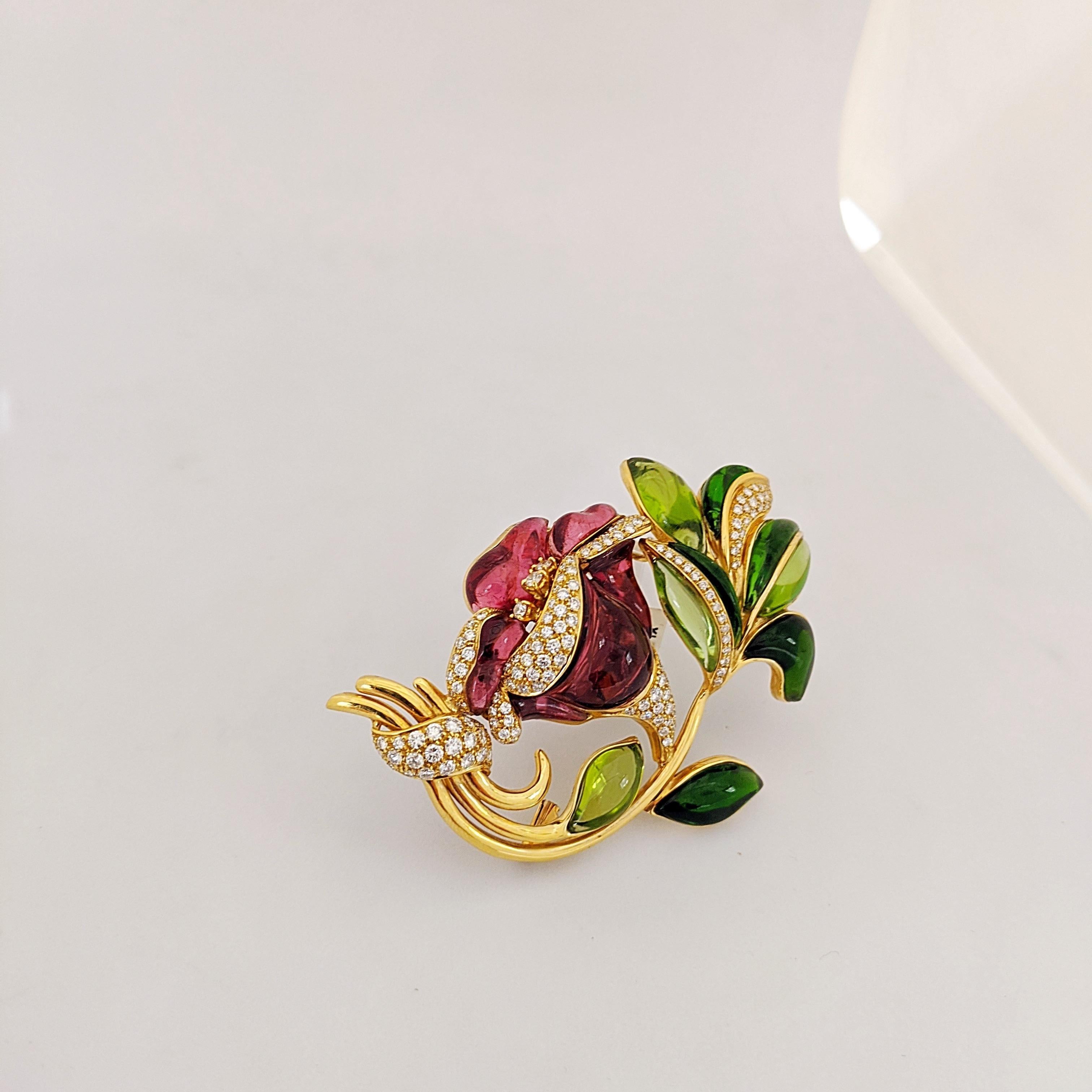 This intricate 18 karat yellow gold flower brooch was made exclusively for Cellini in Italy by Roberto Casarin. Hand carved Rubelite stines  in different shades of pink are set as the petals, along with Green Chrome tourmaline as the leaves. The