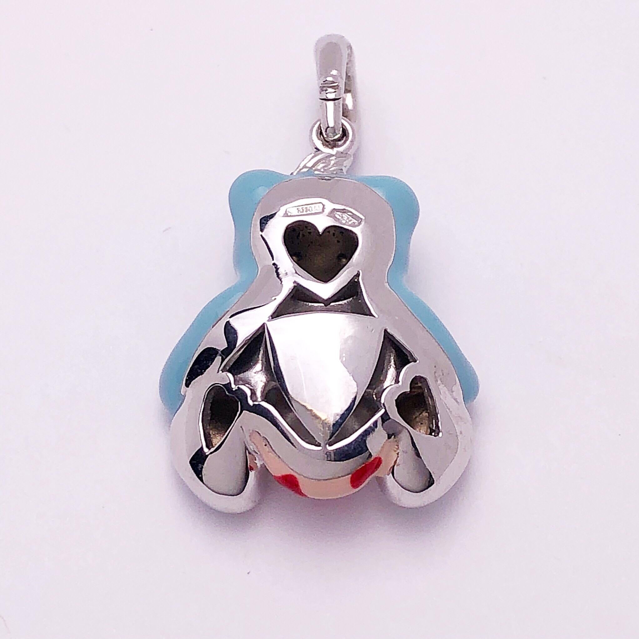 Just the cutest....Teddy bear charm made exclusively for Cellini by Ambrosi of Italy.

This 18 karat white gold teddy bear charm is crafted with light blue enamel for the body. The outfit is light pink with small red hearts. He has blue sapphire