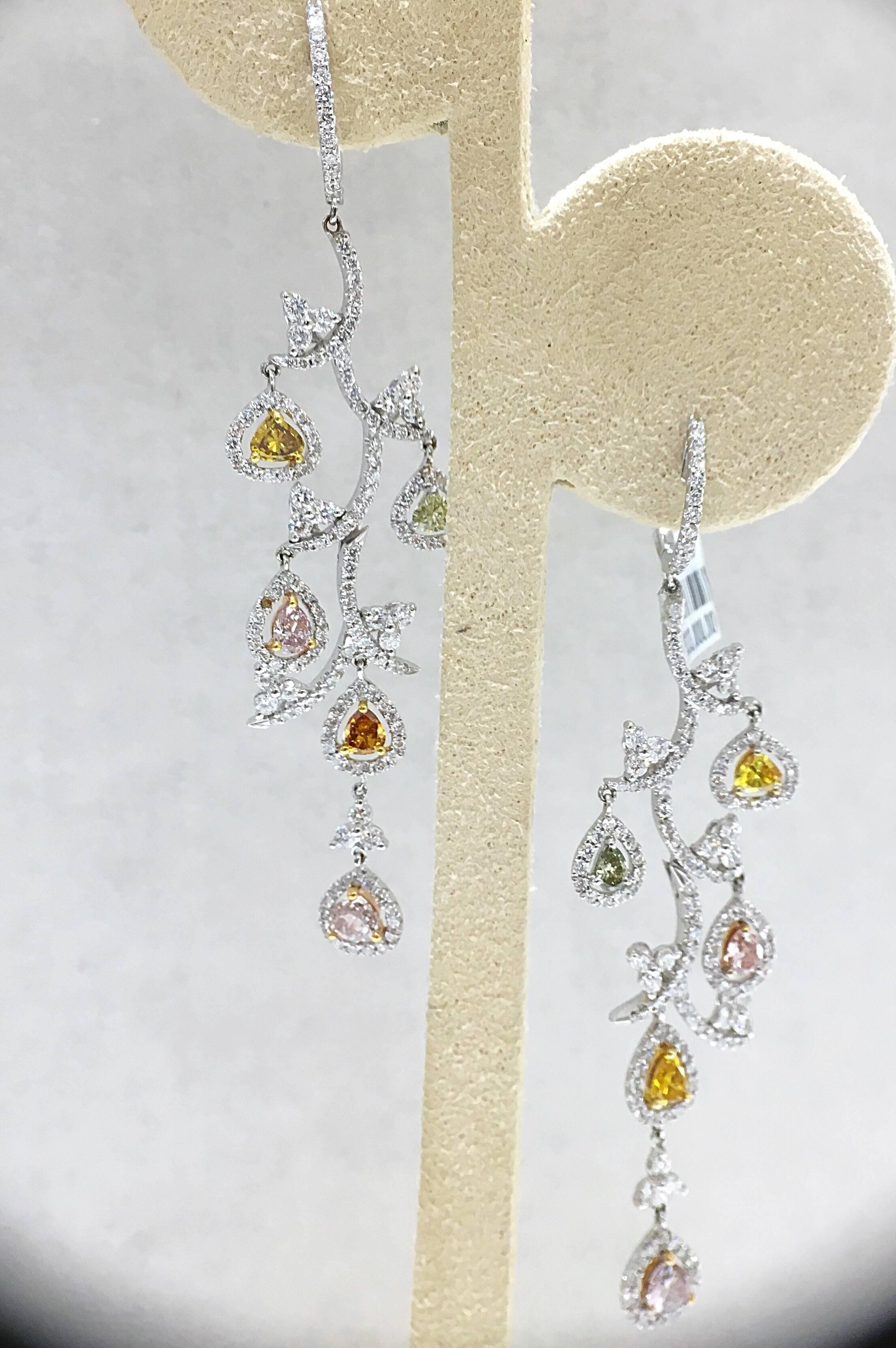 Cellini Jewelers Leaf motif earrings are set in 18 karat white gold with pave white diamonds and accented with natural fancy colored diamonds, including pink and yellow diamonds.  Approximately 2.75