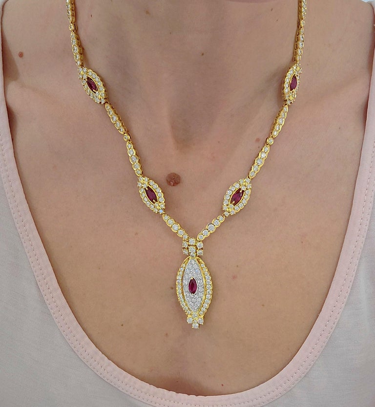 Retro classic 18 karat yellow gold necklace. The necklace is designed as a chain with four marquis shaped motifs. Each centers a marquis ruby surrounded by round brilliant diamonds. The drop part of the necklace is a larger marquis motif with a
