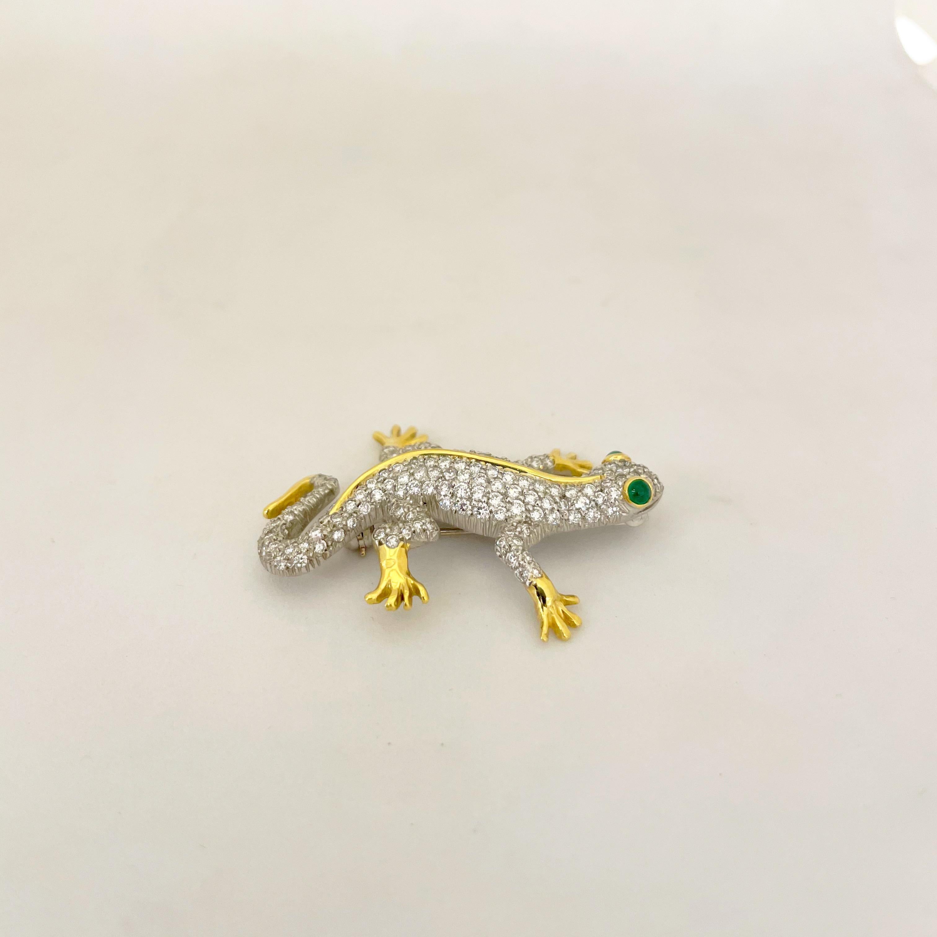 This adorable Cellini  platinum and 18 karat yellow gold salamander brooch is beautifully set with round brilliant diamonds. His body is detailed with hi polished yellow gold for his feet and spine. His eyes are set with cabochon emerald eyes. The
