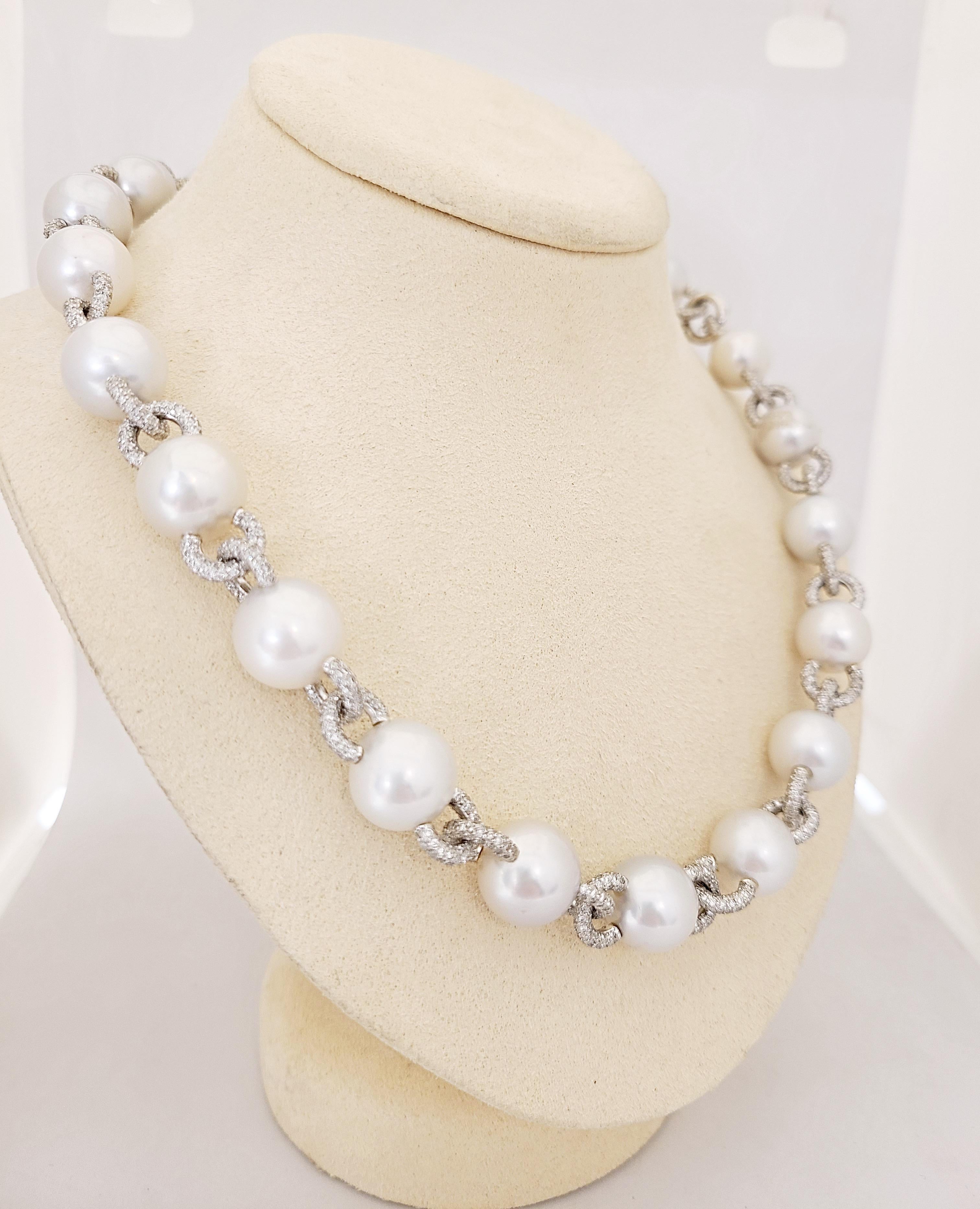 A very classic and wearable pearl and diamond necklace. The necklace is designed with 22 South Sea Pearls 12.5mm x 11.6 mm. The pearls are connected by 18 karat white gold diamond pave links. The combination of links and pearls joins together a