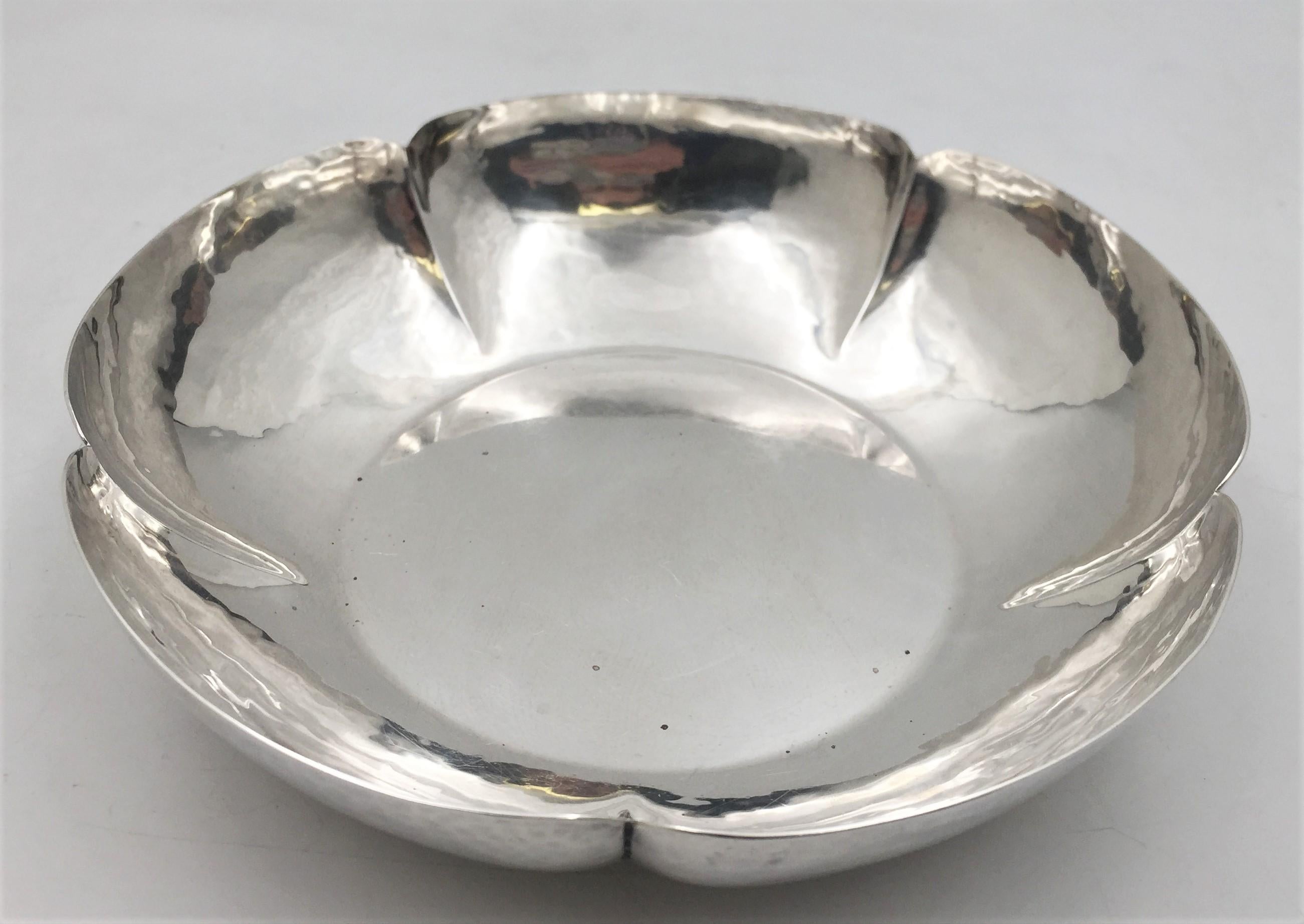 Cellini sterling silver, hand-hammered bowl in Mid-Century Modern style, with a beautiful geometric, multi-lobed design. It measures 9'' in diameter by 2'' in height, weighs 16.9 troy ounces, and bears hallmarks as shown.

Cellini Craft, Ltd., was a