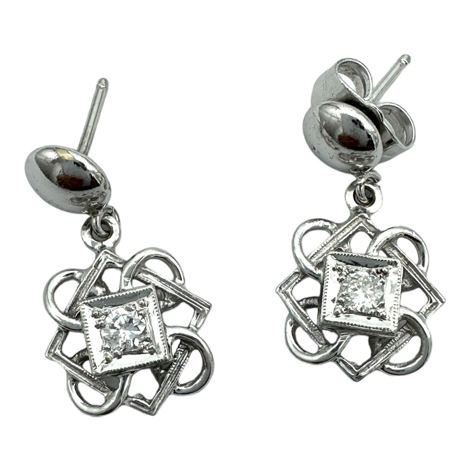 Show your style with these 14k white gold Celtic diamond dangle earrings. Crafted with the finest stones, these earrings feature two Celtic diamonds that will make a statement. Enjoy the beauty of classic Celtic design with a modern spin.
14-karat