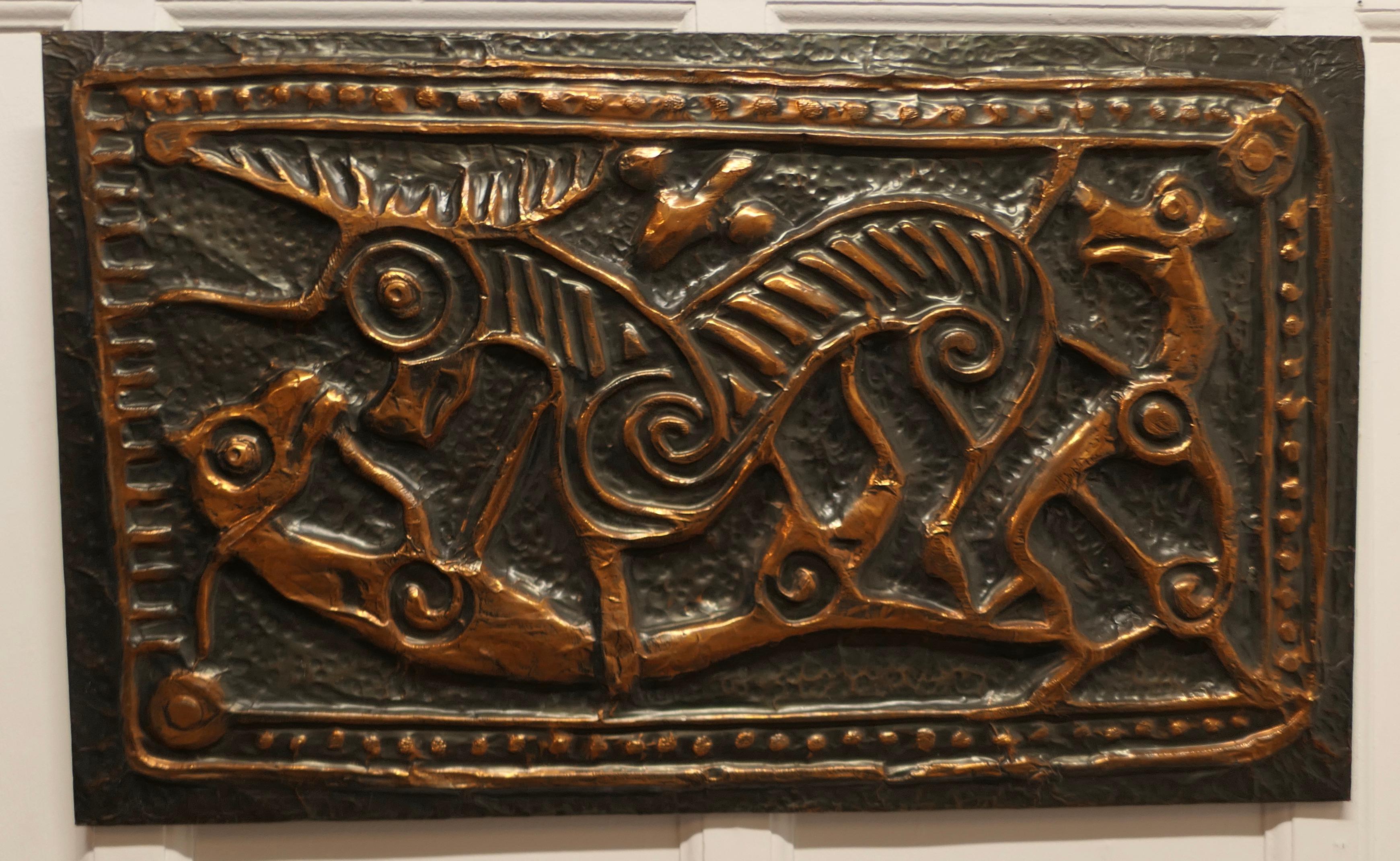 Celtic Art Copper Mural from Ireland, Celtic Animals 

A hand made beaten copper abstract design of dogs and a stag hunting made in Ireland 

A very striking piece with its origin in the book of Kells, the mural is 22” high, and 36” wide
SW89