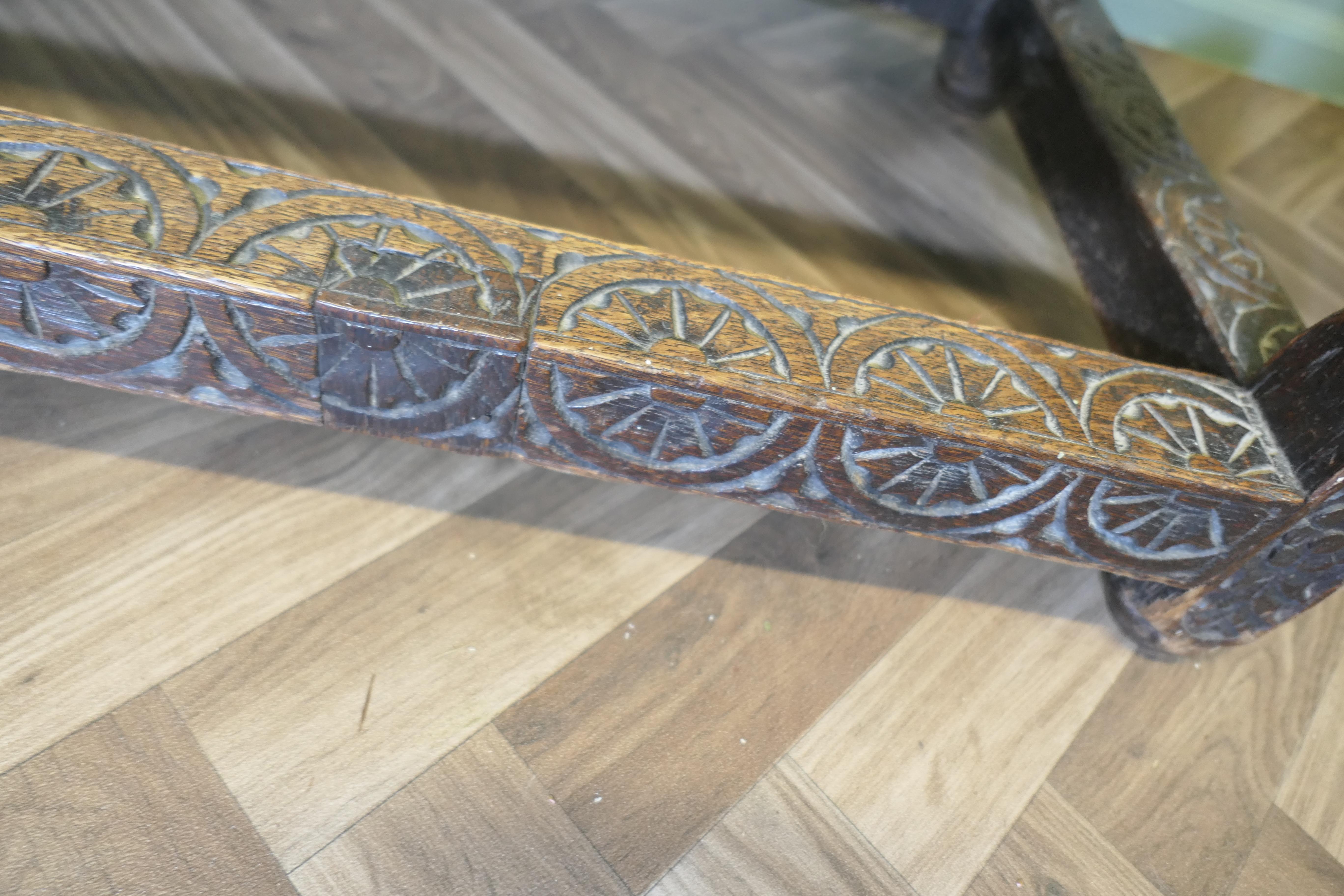 Celtic Carved Oak Occasional Table
 
A charming Carved Oak Occasional Table, it has a carved border along the top edge with a carved apron to the front and more carving to the main front stretcher
The table has turned legs and stretchers all the way
